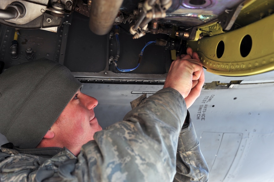 MINOT AIR FORCE BASE, N.D. -- Senior Airman George Querry, 5th Aircraft Maintenance Squadron electrical and environmental specialist, works on the anti-ice system inside the compartment of one of the engines on a B-52H Stratofortress, here April 1. The Airmen of Team Minot perform this kind of maintenance daily to keep Minot AFB’s bomber fleet ready to defend this country’s freedom at a moment’s notice. (U.S. Air Force photo/Staff Sgt. Keith Ballard)  