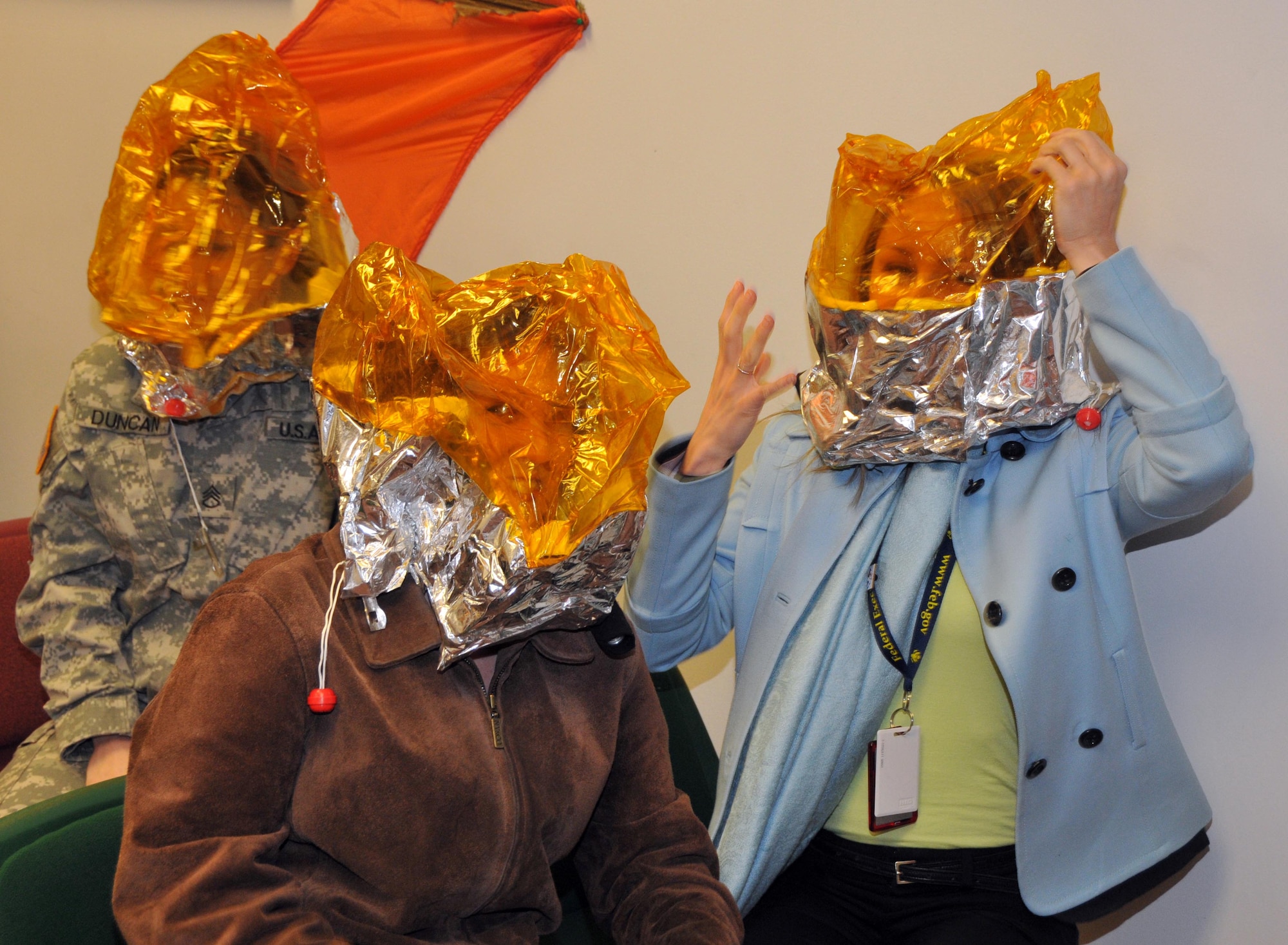 Members of the Federal Outreach Leadership Development tour try out emergency oxygen hoods during their tour of the 934th Aircrew Flight Equipment section April 5.  (Air Force Photo/Paul Zadach)