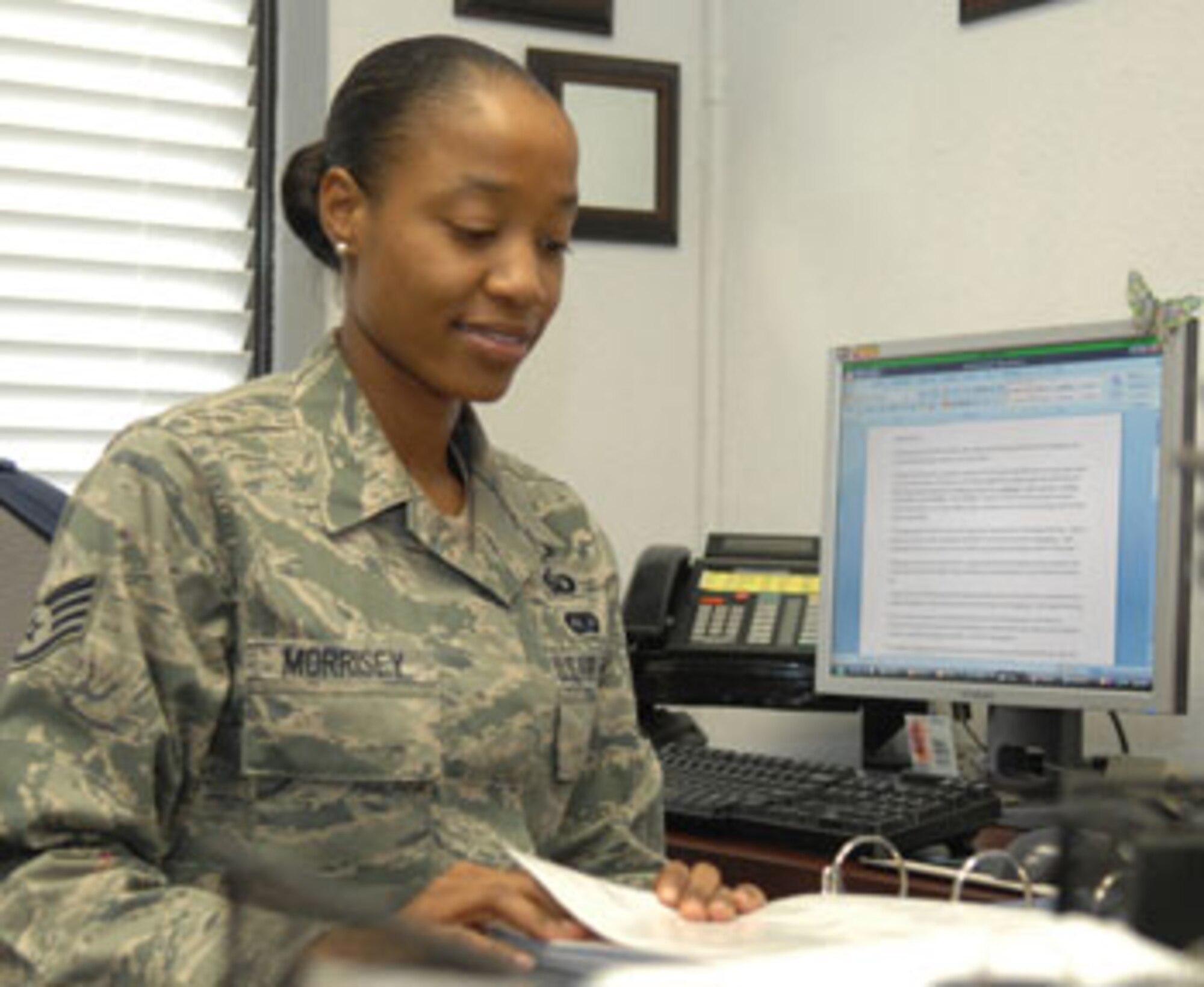 Staff Sgt. Sharon Morrisey, a chaplain assistant from Pope Chapel, checks the visitation schedule while deployed.
