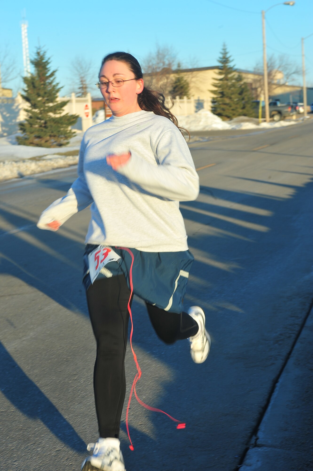 MINOT AIR FORCE BASE, N.D. – Senior Airman Jessica Kloth-Fay crosses the finish line at the end of the April Fool’s day 5K run here April 1. This annual event is open to all of Team Minot and is one of the ways the base helps to promote fitness among its Airmen. (U.S. Air Force Photo/Senior Airman Jesse Lopez) 