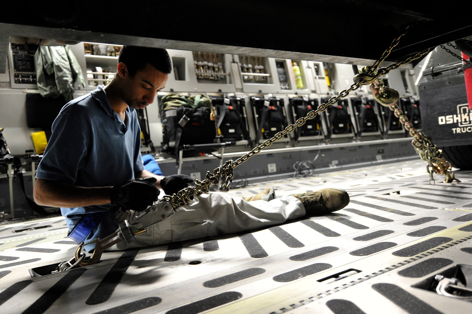Senior Airman Kristofer Lee, contingency response team radio frequency transmission specialist assigned to the 621st Contingency Response Wing, secures a fuel truck to the floor of a C-17 Globemaster III at Galeao Air Base, Rio de Janeiro, Brazil in support of President Obama's visit to Latin America March 19-23. Thirty-five Airmen tasked for the contingency response team expanded capability at airfields in Brazilia and Rio de Janeiro, Brazil, Santiago, Chile and San Salvador, El Salvador in support of air mobility requirements for presidential personnel and cargo.(U.S. Air Force photo by Tech. Sgt. Laura K. Deckman/released)