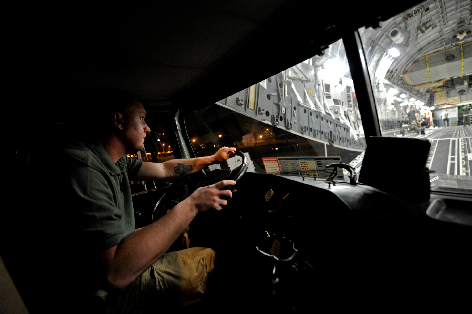Staff Sgt. Joshua Gaines, contingency response team air transportation specialist assigned to the 621st Contingency Response Wing, loads a fuel truck onto a C-17 Globemaster III at Galeao Air Base, Rio de Janeiro, Brazil in support of President Obama's visit to Latin America March 19-23. Thirty-five Airmen tasked for the contingency response team expanded capability at airfields in Brazilia and Rio de Janeiro, Brazil, Santiago, Chile and San Salvador, El Salvador in support of air mobility requirements for presidential personnel and cargo.(U.S. Air Force photo by Tech. Sgt. Laura K. Deckman/released)