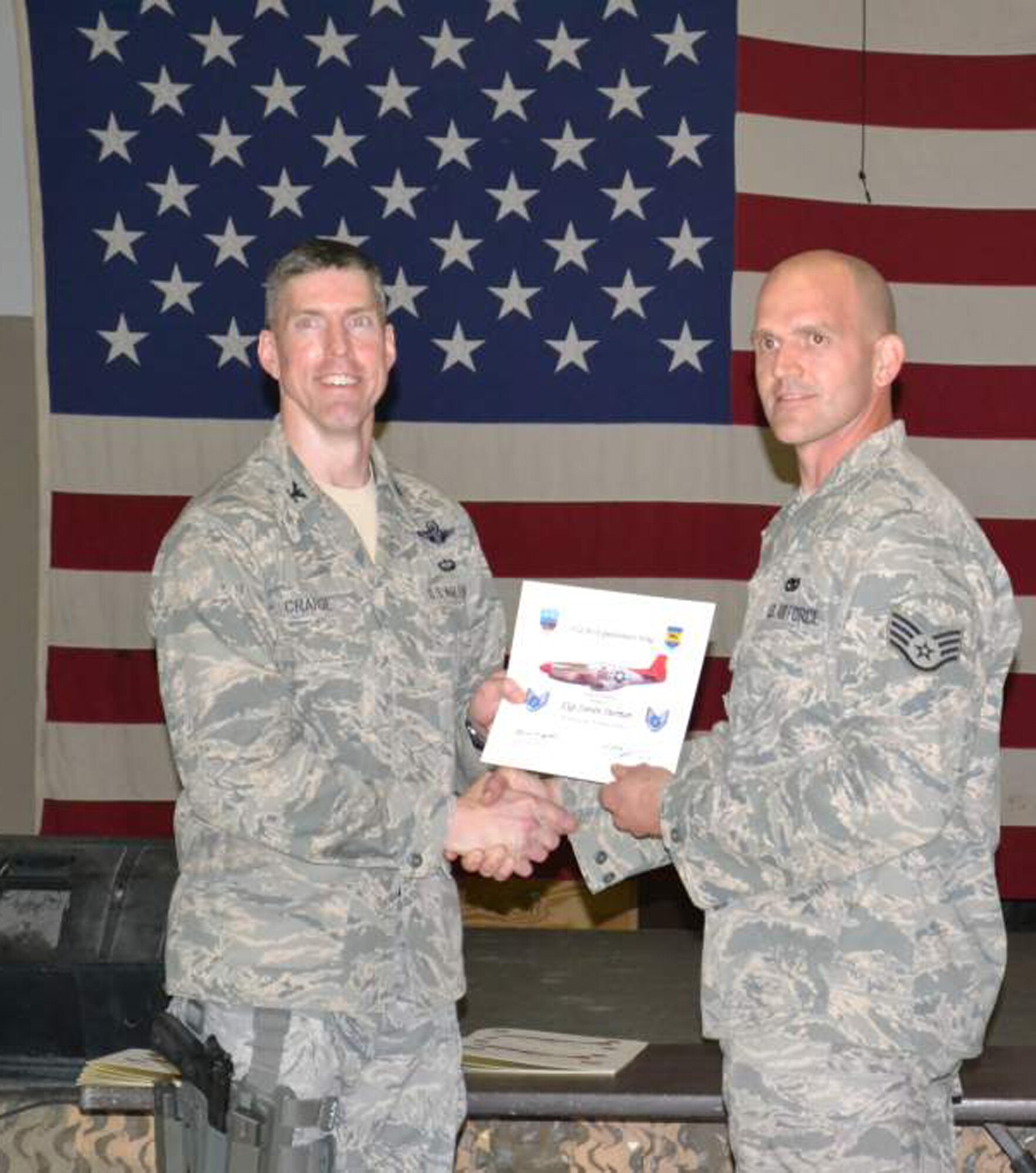 WRIGHT-PATTERSON AIR FORCE BASE, Ohio – Col. Christopher E. Craige, 332nd AEW vice commander, presents Staff Sgt. Steven Sherman, 87th Aerial Port Squadron currently deployed with the 332nd Expeditionary Logistics Readiness Squadron, Joint Base Balad, Iraq, with a certificate for his recent promotion to staff sergeant. (Courtesy photo) 