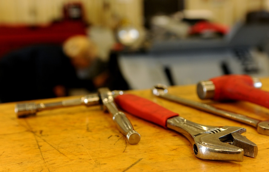 Tools wait as members of the 23rd Equipment Maintenance Squadron aerospace ground equipment maintenance shop continue working on the components of a bomb lift truck inside the AGE compound at Moody Air Force Base, Ga., April 5. The AGE maintenance shop members work extra hours to ensure the ground equipment is available for use by aircraft and personnel. (U.S. Air Force photo/Airman 1st Class Benjamin Wiseman)(RELEASED)