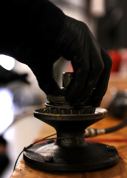 A bearing is greased by a member of the 23rd Equipment Maintenance Squadron aerospace ground equipment crew during routine maintenance at the AGE compound at Moody Air Force Base, Ga., April 5. Grease is used on the bearing to lubricate and cause less wear-and-tear on ground equipment components during use. (U.S. Air Force photo/Airman 1st Class Benjamin Wiseman)(RELEASED)
