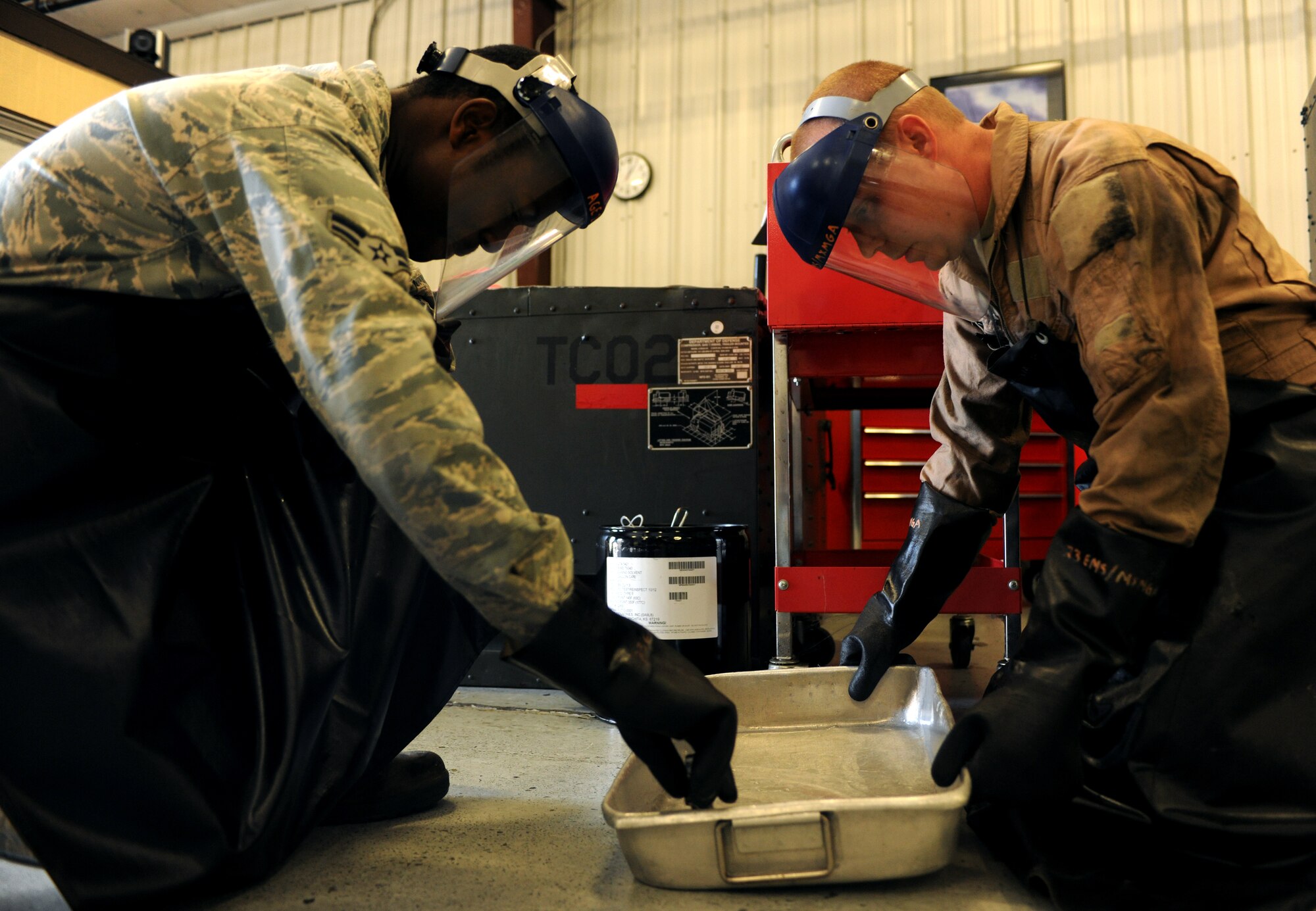 Staff Sgt. David Sartin, 23rd Equipment Maintenance Squadron aerospace ground equipment craftsman, shows Airman 1st Class Salathiel Wesley, 23rd EMS aerospace ground equipment apprentice, how to properly clean components during routine maintenance at the AGE compound at Moody Air Force Base, Ga., April 5. During routine maintenance, ground equipment is run through several inspections for safety and proper use before being put back to work on the flightline.  (U.S. Air Force photo/Airman 1st Class Benjamin Wiseman)(RELEASED)