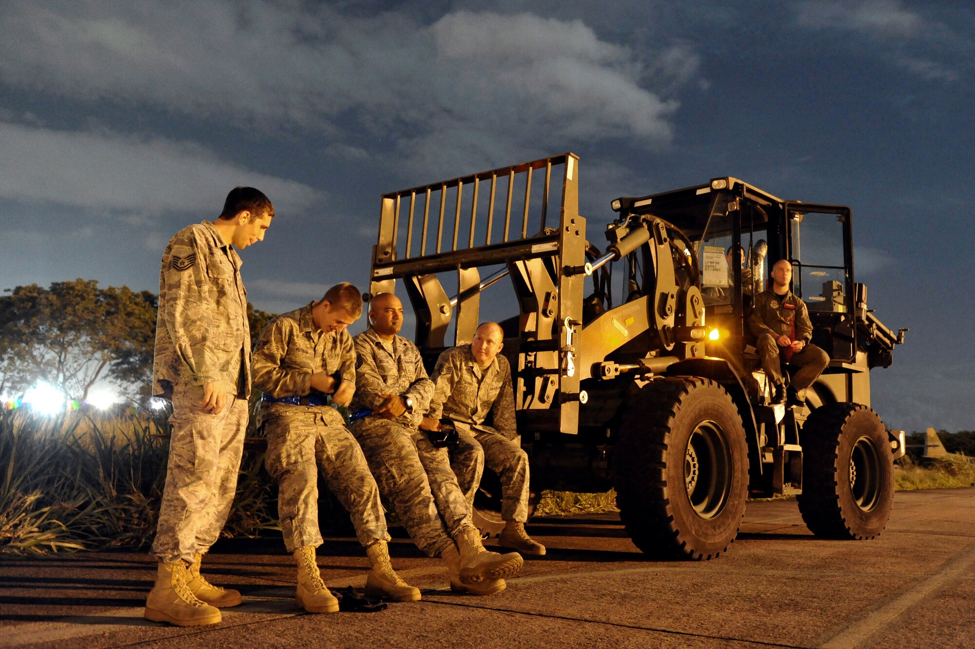 Members of the 621st Contingency Response Wing from Joint Base McGuire-Dix-Lakehurst, N.J., await the arrival of a C-17 Globemaster III at Galeao Air Base, Rio de Janeiro, Brazil in support of President Obama's visit to Latin America March 19-23. Thirty-five Airmen tasked for the contingency response team expanded capability at airfields in Brasilia and Rio de Janeiro, Brazil, Santiago, Chile and San Salvador, El Salvador in support of air mobility requirements for presidential personnel and cargo.(U.S. Air Force photo by Tech. Sgt. Laura K. Deckman/released)