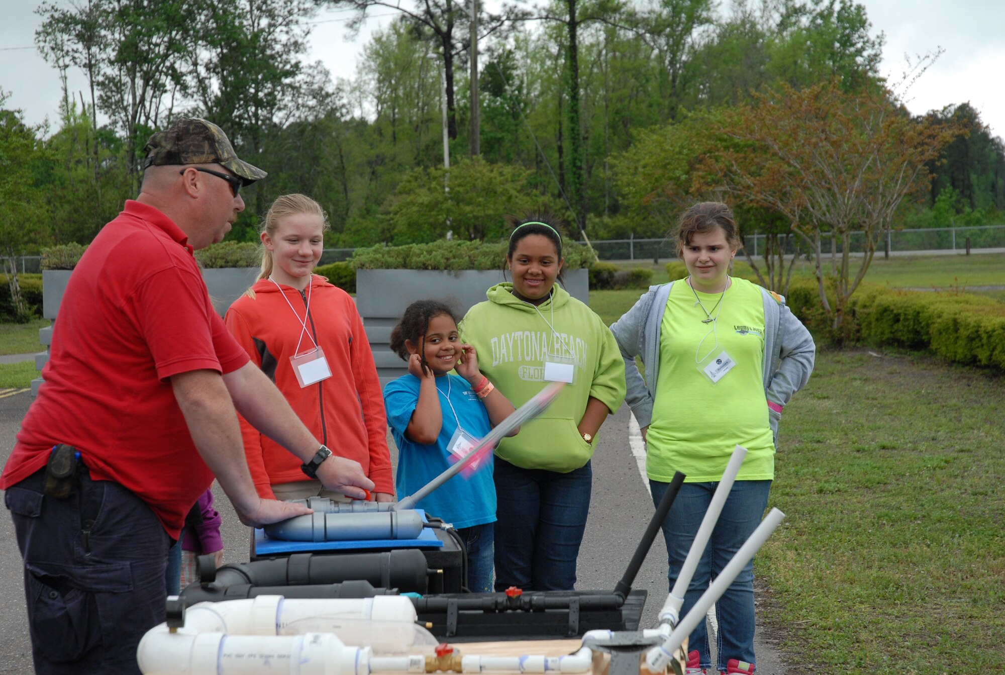 Mark Frank helps military kids launch paper rockets during a Spring Break Science Camp hosted by Operation Military Kids and STARBASE Florida at the 125th Fighter Wing, March 29, 2011. The camp provided the kids with an opportunity to meet with other military youth and learn more about science and math. Photo by Staff Sgt. Blair Heusdens