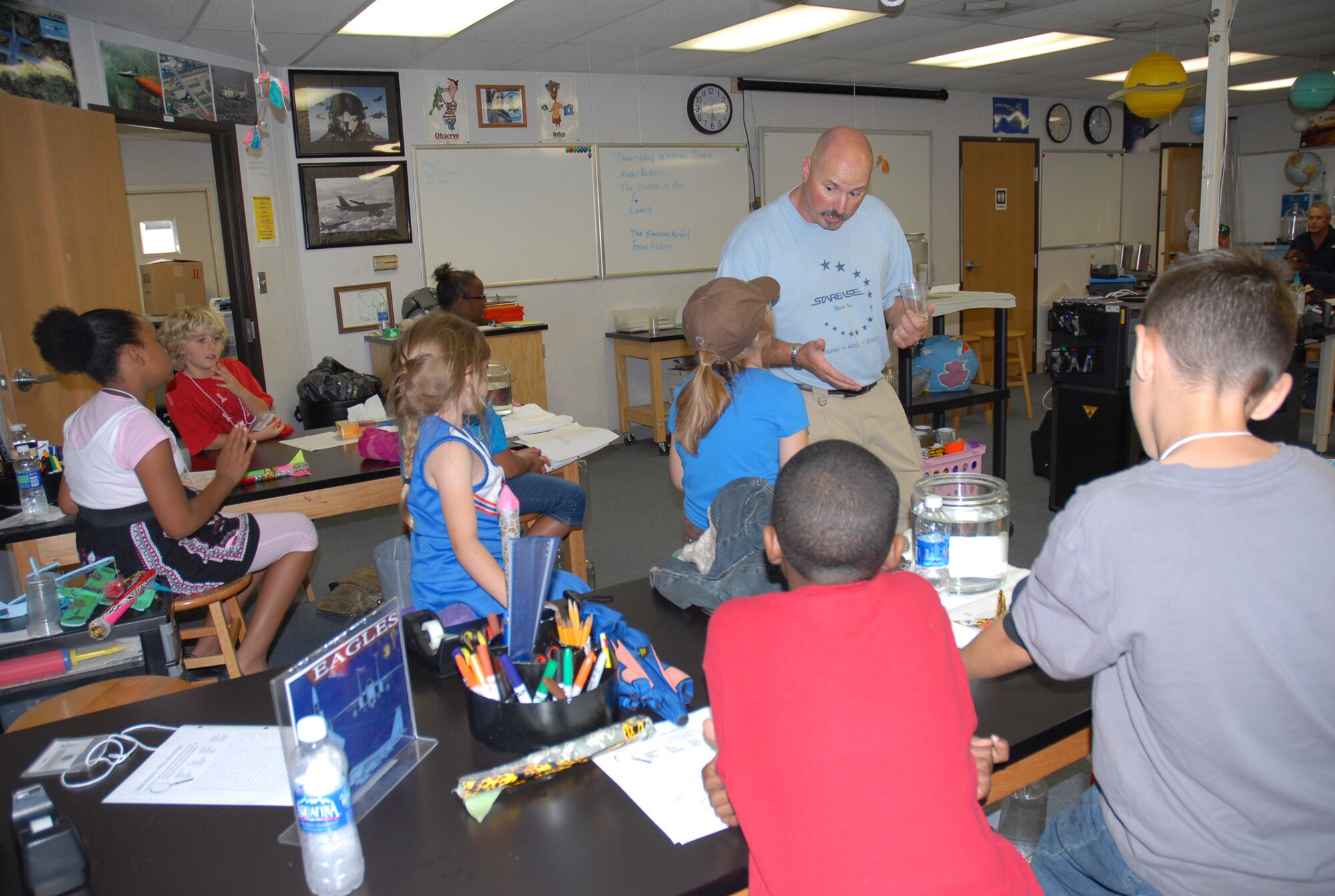 Lee McCook, a teacher at STARBASE Florida, demonstrates a science experiement to military children during a Spring Break Science Camp, March 29, 2011, at the 125th Fighter Wing in Jacksonville, Fla. The camp was hosted by Operation Military Kids and STARBASE Florida. Photo by Staff Sgt. Blair Heusdens