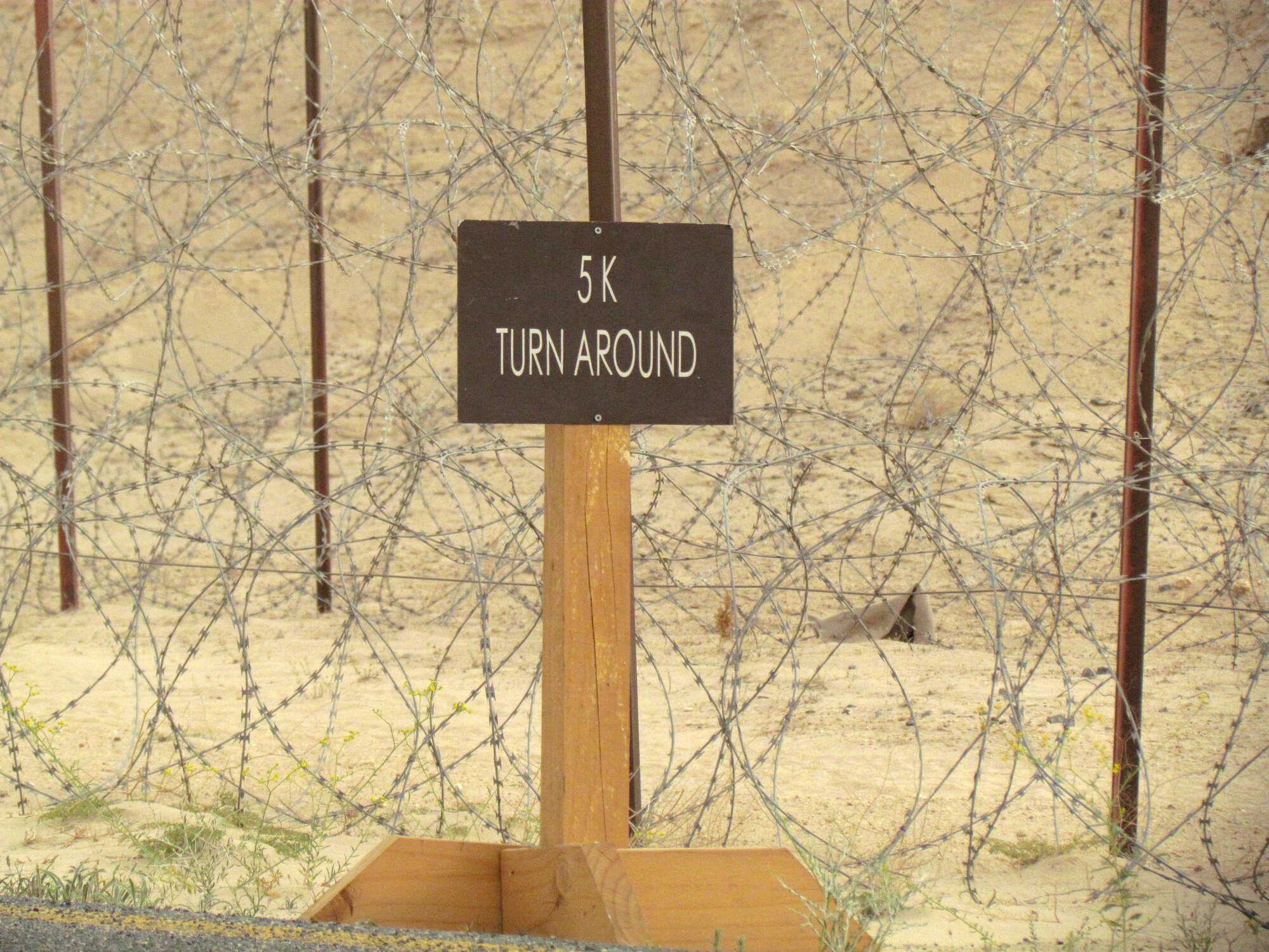 This sign marked the halfway point for the more than 100 members of the 386th Air Expeditionary Wing who participated in the Rock Chapel's Physically Fit, Spiritually Strong 5k run April 2, at an undisclosed location in Southwest Asia. (U.S. Air Force photo by Tech. Sgt. Sandra Bradley)                         