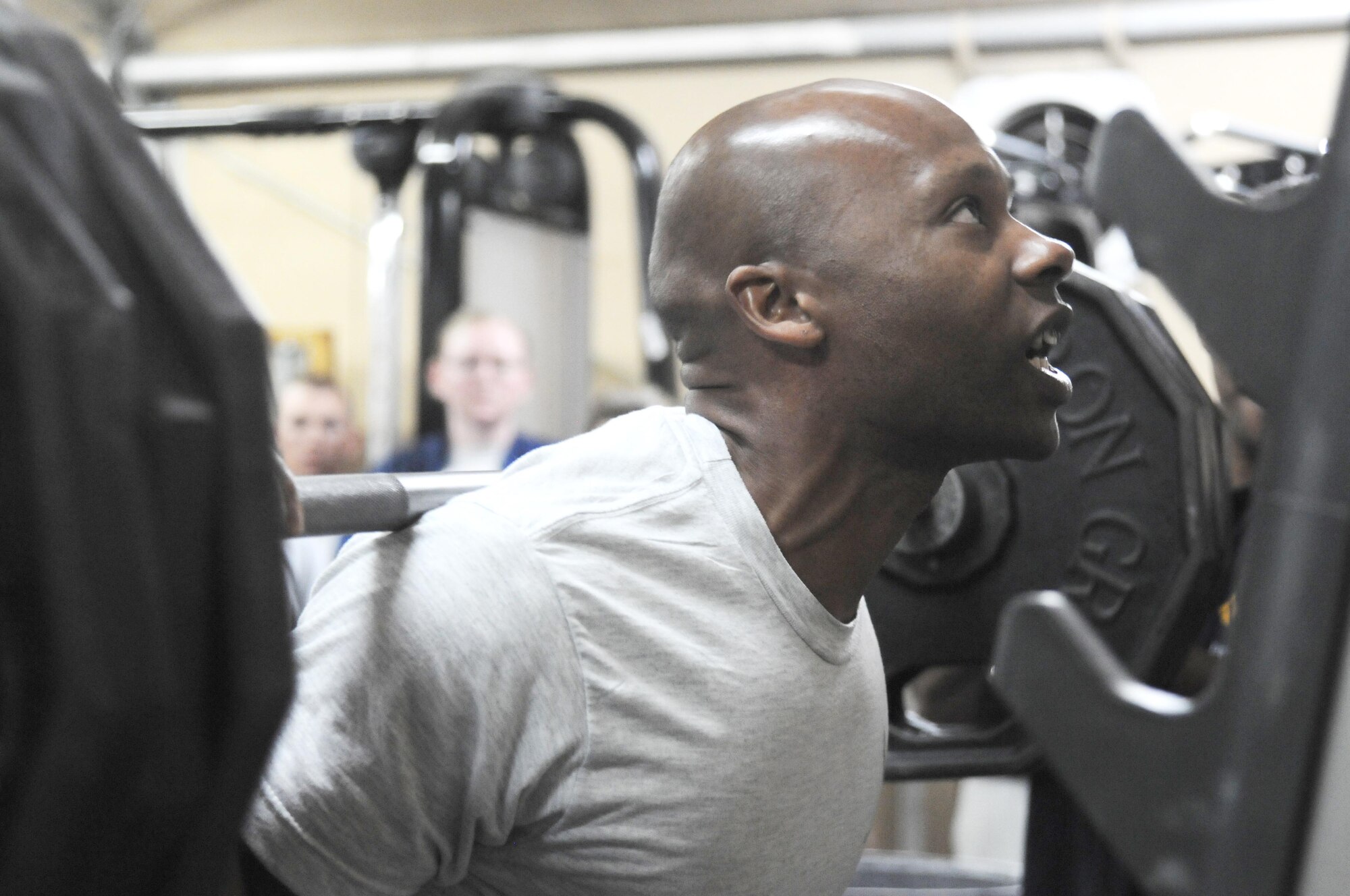 Staff Sgt. Bobby Harrison, 386th Expeditionary Logistics Readiness Squadron, begins his first squat attempt out of three during the Life Support Area's Weightlifting Competition March 29. Sergeant Harrison took first place in the 150 and under weight class. Members of the 386th Air Expeditionary Wing participated in the three event competition which featured squat, bench press and dead lift. (U.S. Air Force Photo by Staff Sgt. Patrice Clarke)