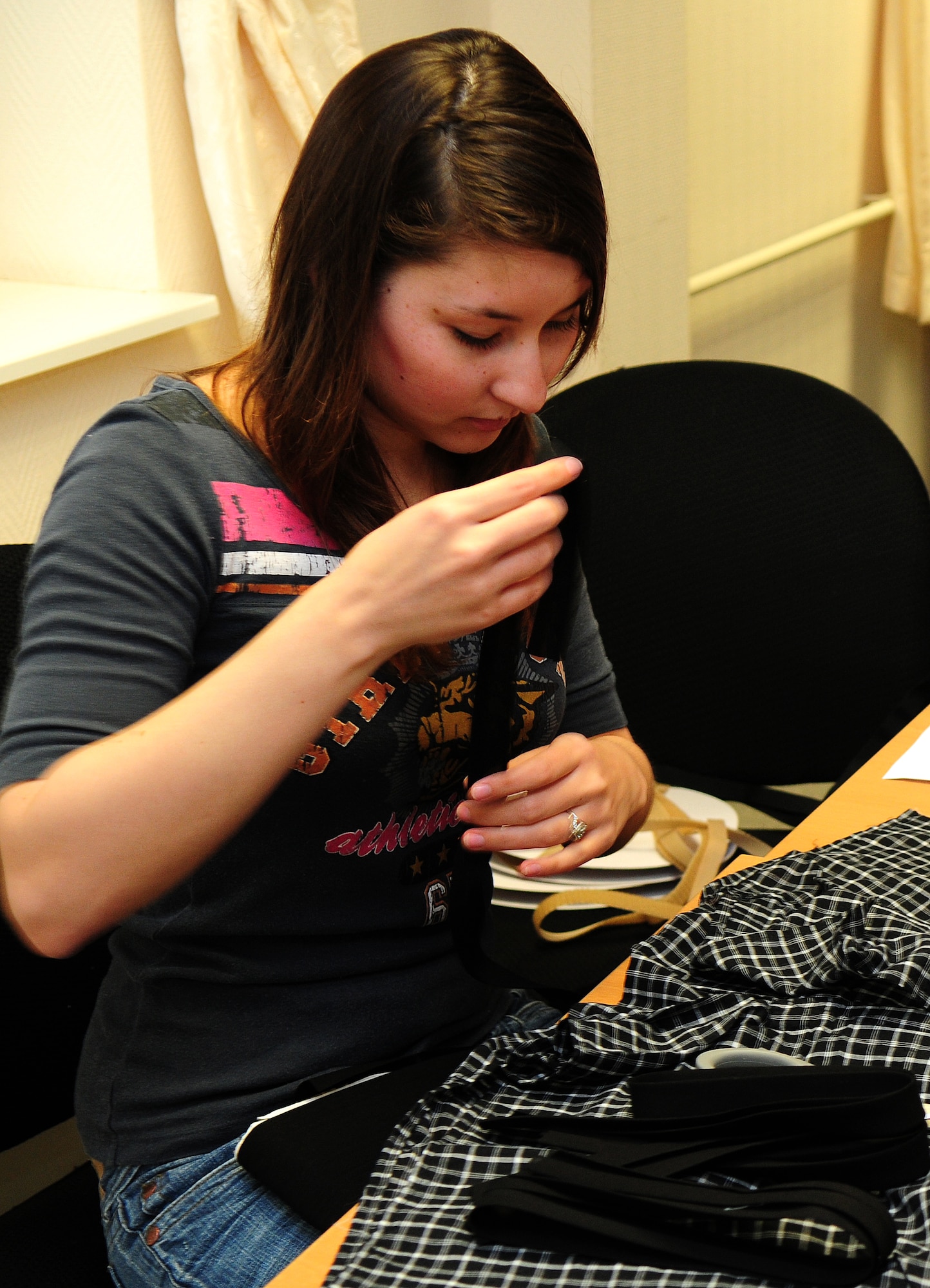 SPANGDAHLEM AIR BASE, Germany —Jessica Ward, dry cleaner employee, sizes and cuts fabric fastener strips for underwear March 31 at the Airman and Family Readiness Center here. Sew Much Comfort modifies underwear to be used by wounded warriors with limited mobility. Volunteers have been meeting monthly for more than two years and produce about 150 pairs of modified undergarments annually at the Landstuhl Regional Medical Center in Landstuhl, Germany. (U.S. Air Force Photo/Airman 1st Class Dillon Davis)