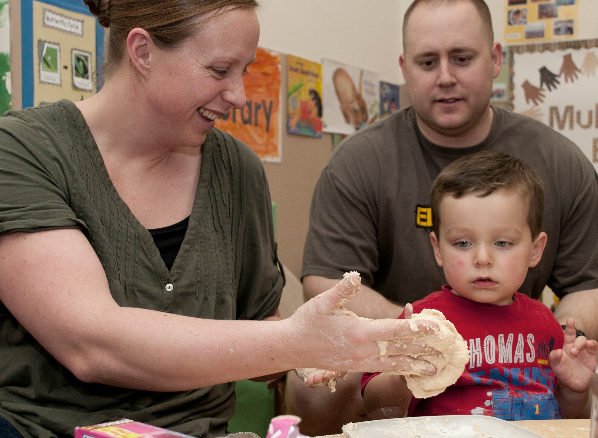 Tech. Sgt. Sally White and her husband, Chris, knead dough with their son Zachary during the children’s science fair at the Child Development Center March 30, 2011, at Incirlik Air Base, Turkey. During the science fair, children and parents participated in hands-on activities designed around scientific principles. The event was held to promote awareness of the CDC’s new accreditation with the National Association for the Education of Young Children. (U.S. Air Force photo by Staff Sgt. Alexandre Montes)