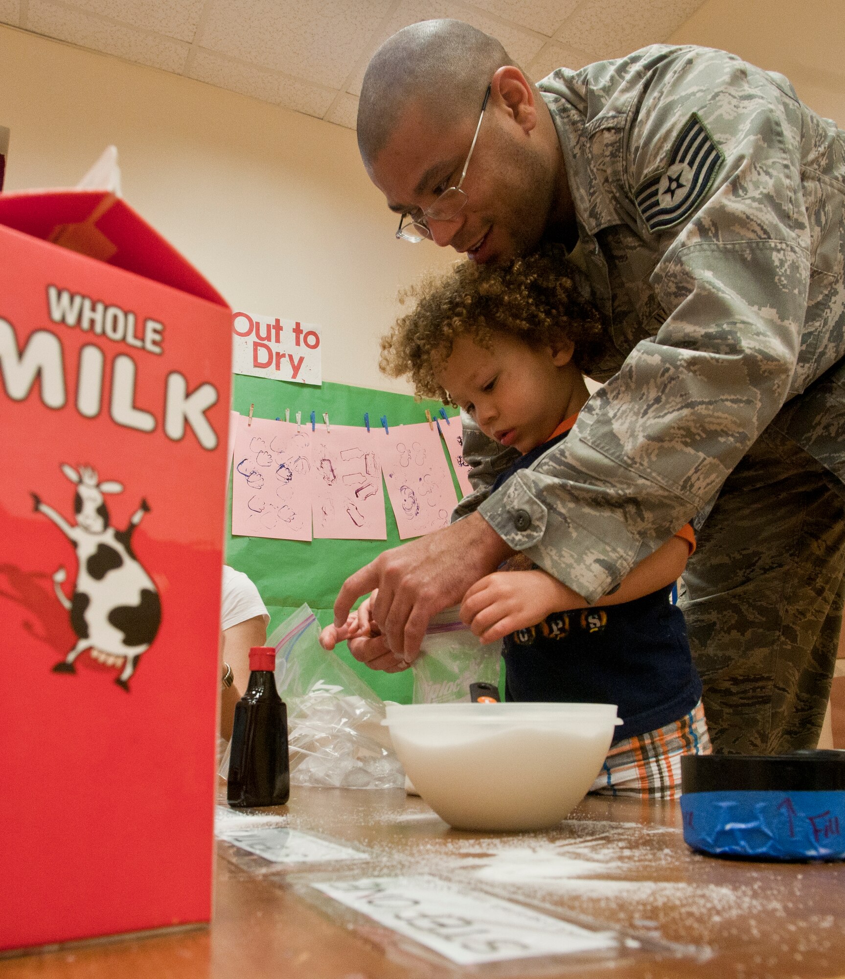 Tech. Sgt. Travis Jalaliddin, from the 39th Maintenance Squadron, and his son, Travis, prepare homemade ice cream during the children’s science fair at the Child Development Center March 30, 2011, at Incirlik Air Base, Turkey. During the science fair, children and parents participated in hands-on activities designed around scientific principles. The event was held to promote awareness of the CDC’s new accreditation with the National Association for the Education of Young Children. (U.S. Air Force photo by Staff Sgt. Alexandre Montes)
