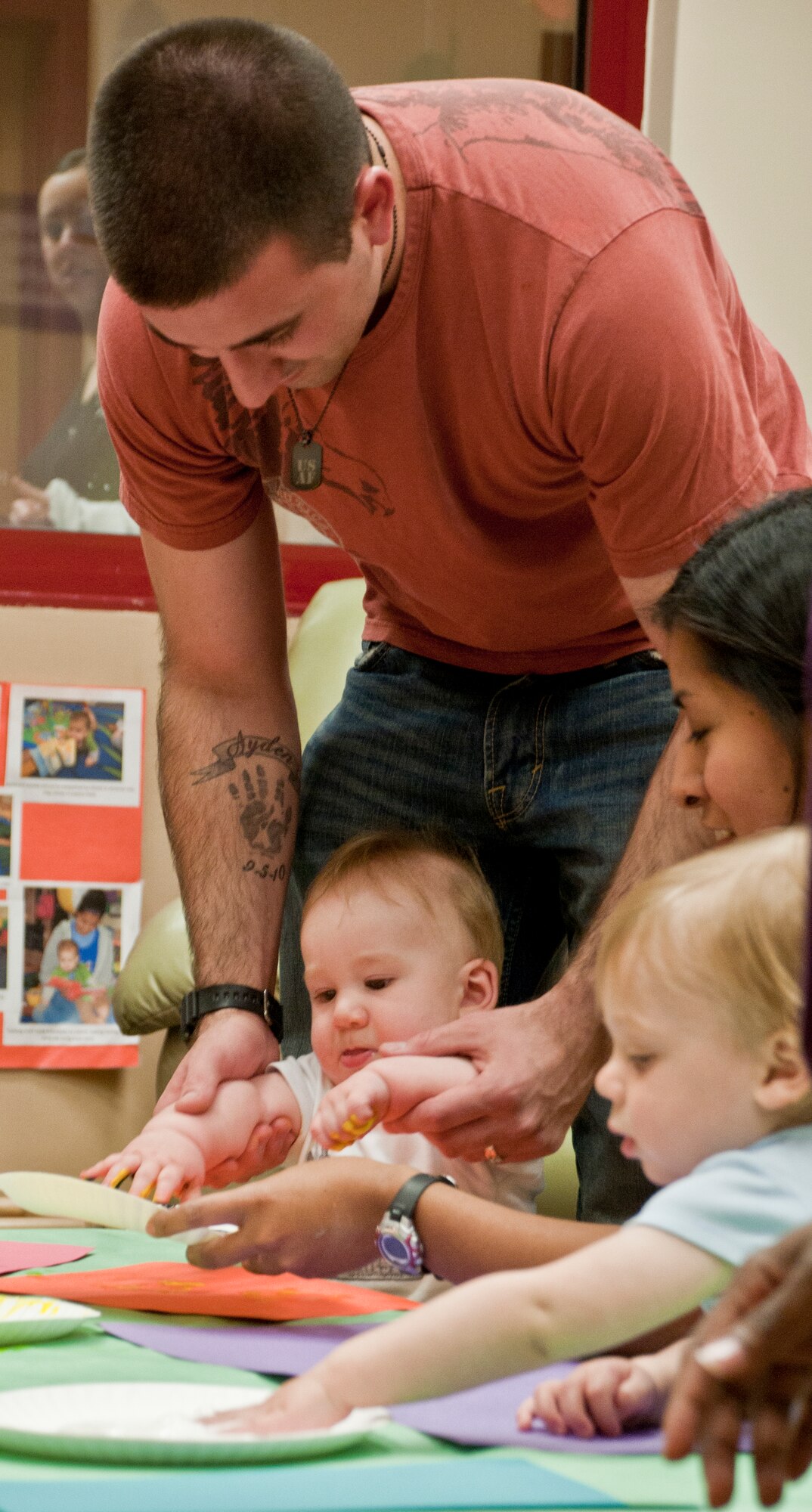 Senior Airman Jason Kimball finger paints with his son, Ayden, during the children’s science fair at the Child Development Center March 30, 2011, at Incirlik Air Base, Turkey. During the science fair, children and parents participated in hands-on activities designed around scientific principles. The event was held to promote awareness of the CDC’s new accreditation with the National Association for the Education of Young Children.  (U.S. Air Force photo by Staff Sgt. Alexandre Montes)