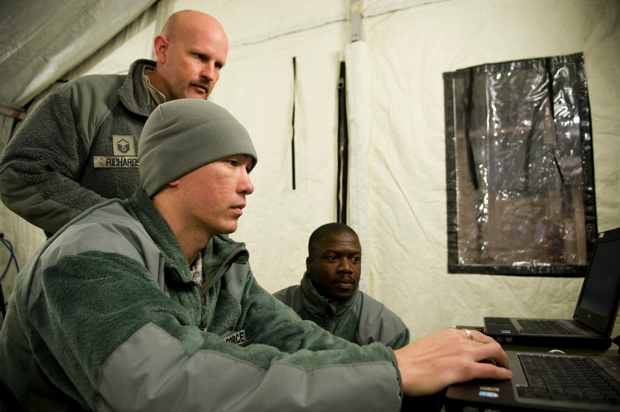 YOKOTA AIR BASE, Japan -- Staff Sgt. Terry Shoup, Master Sgt. Ty Richards and Tech Sgt. Dwight Brown, Air Force Radiation Assessment Team, stationed out of Wright-Patterson Air Force Base, sample tap water from Yokota Air Base's water supply to make sure water at Yokota remains safe to drink March 25. So far there have been no positive findings of any kind in the water. (U.S. Air Force photo/Staff Sgt. Chad C. Strohmeyer)