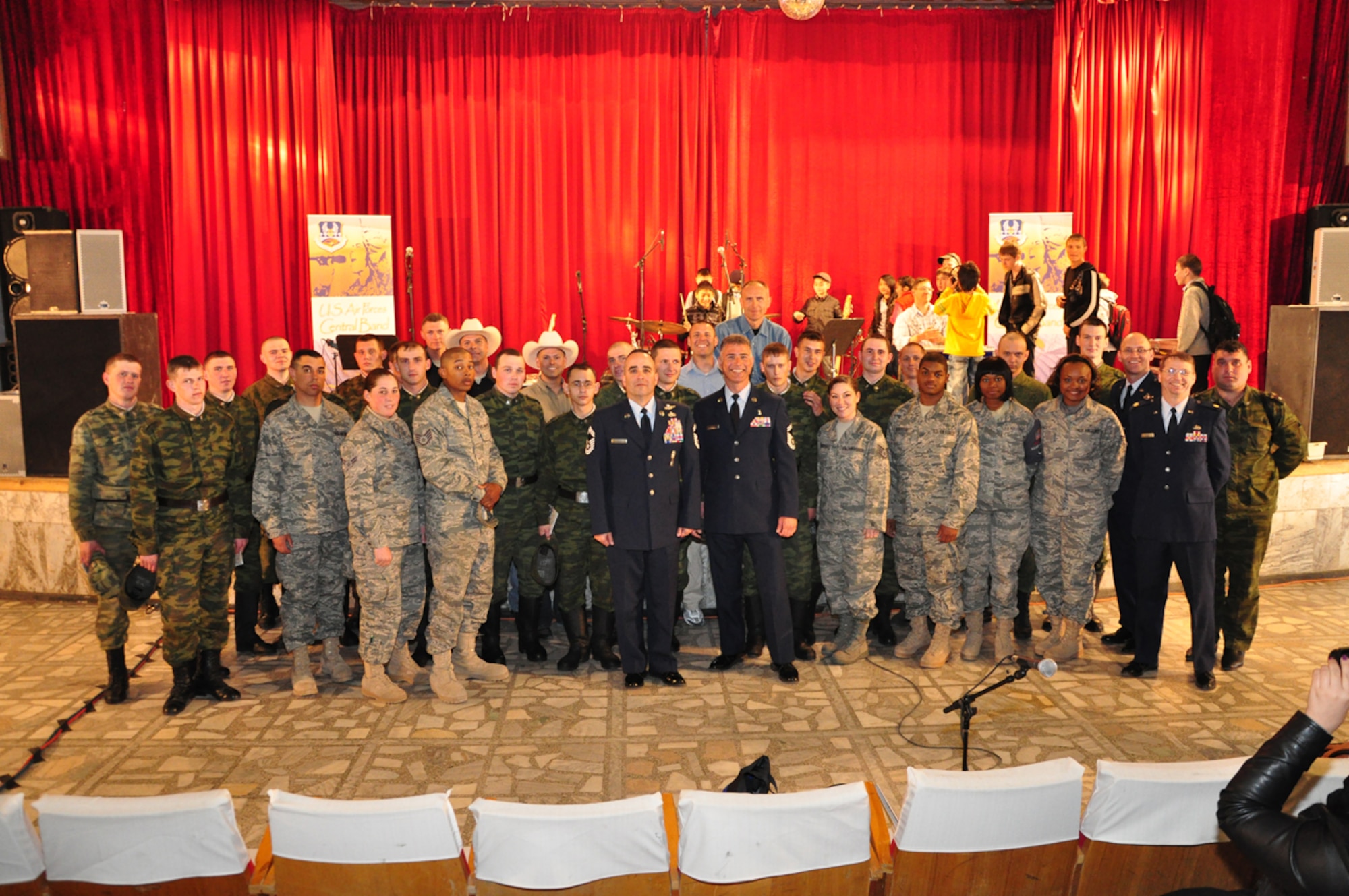 Russian Airmen from Kant Air Base and their American counterparts from the Transit Center at Manas join Wild Blue Country for a group picture after a performance at the House of Culture in Kant April 5. Wild Blue Country, the current AFCENT band deployed to the Central Command Area of Responsibility, is currently on tour in the Republic of Kyrgyzstan. The band hails from Peterson Air Force Base, Colorado Springs, Colo. (U.S. Air Force photo/Master Sgt. Daniel Nathaniel)