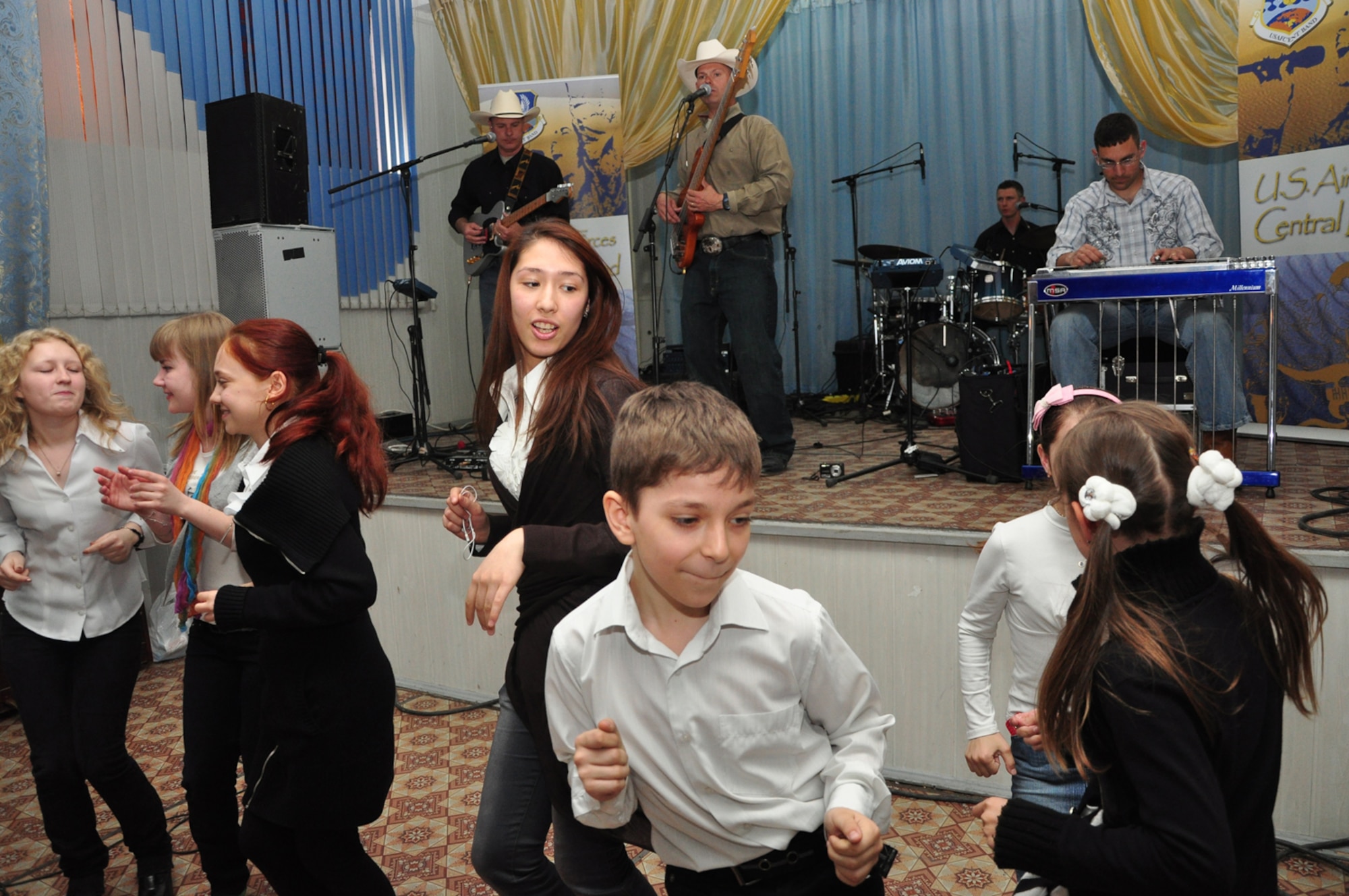 Students from School-Gymnasium #62 get up and dance to the music of Wild Blue Country, April 1. Wild Blue Country, the current AFCENT band deployed to the Central Command Area of Responsibility, is currently on tour in the Republic of Kyrgyzstan. The band hails from Peterson Air Force Base, Colorado Springs, Colo. (U.S. Air Force photo/Master Sgt. Daniel Nathaniel)
