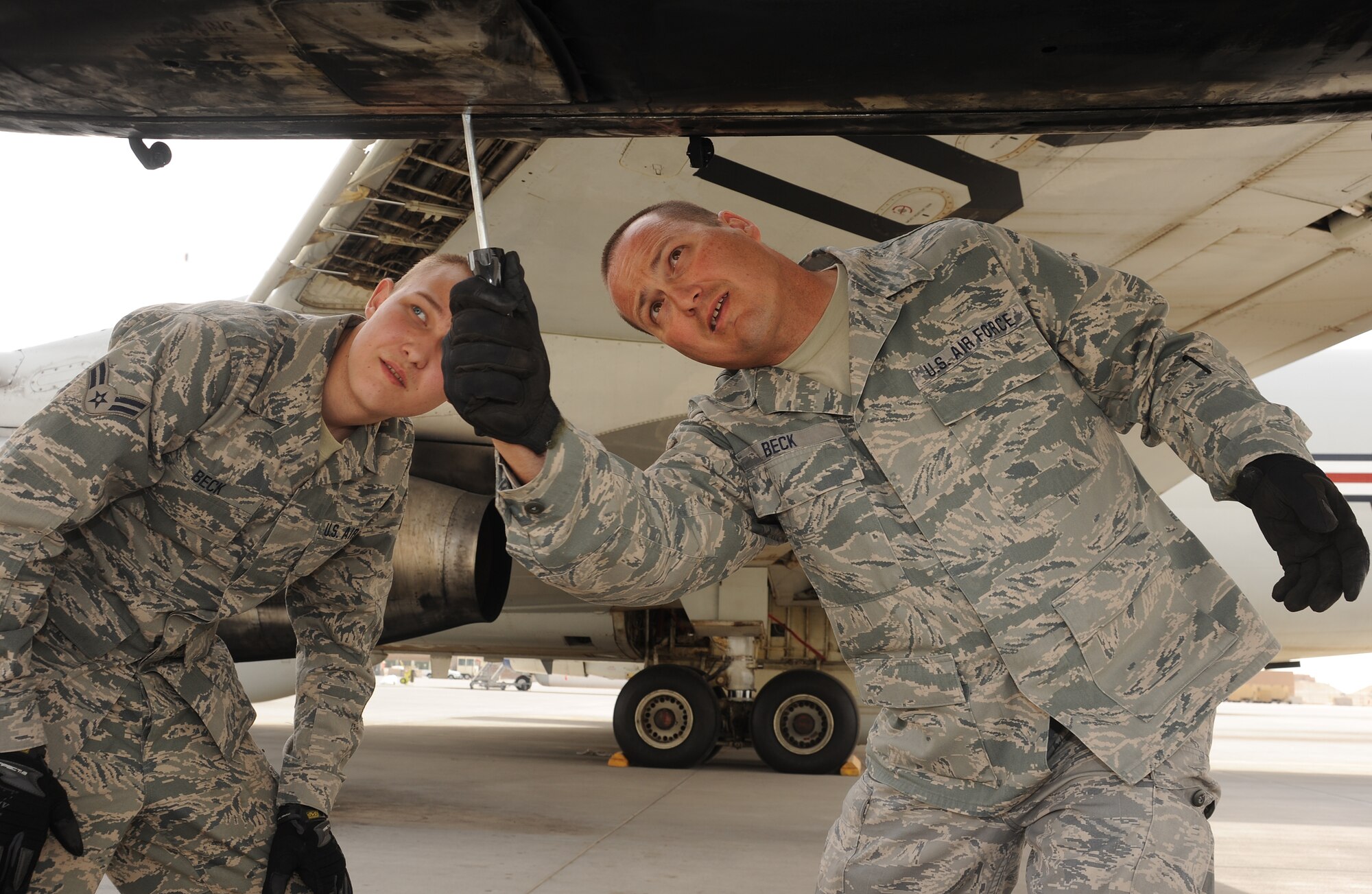 Airman 1st Class Kyle Beck and Tech. Sgt. Al Beck, 7th Expeditionary Aircraft Maintenance Unit, close the engine cowl on an E-8 Joint Surveillance Attack Radar System aircraft at an undisclosed location in Southwest Asia, March 31.  (U.S. Air Force photo/Staff Sgt. Liliana Moreno)          