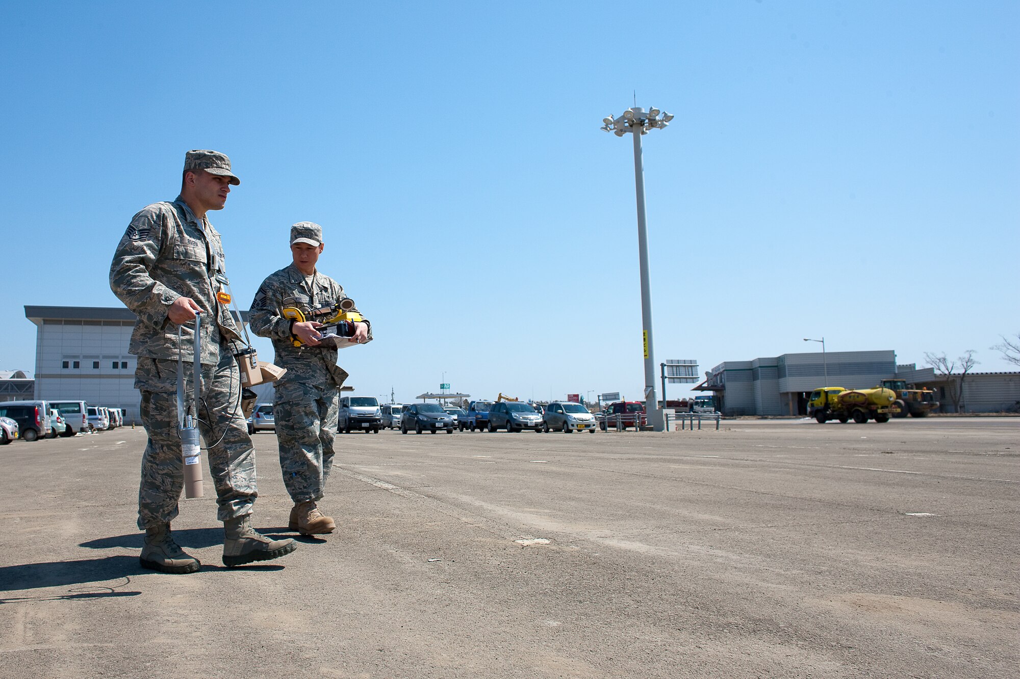 SENDAI AIRPORT, Japan -- Staff Sgt. Kevin Rivera (left) and Senior Master Sgt. Dean Kim, from the Air Force Radiation Assessment Team, use a sodium iodide detector to check for radiation at Sendai Airport, April 5, 2011.  Sergeant Rivera and Sergeant Kim checked for radiation in the air, soil and vegetation. The AFRAT provides commanders and other key decision-makers with risk-based recommendations to maximize force protection while meeting critical mission requirements. (U.S. Air Force photo/Osakabe Yasuo)  
