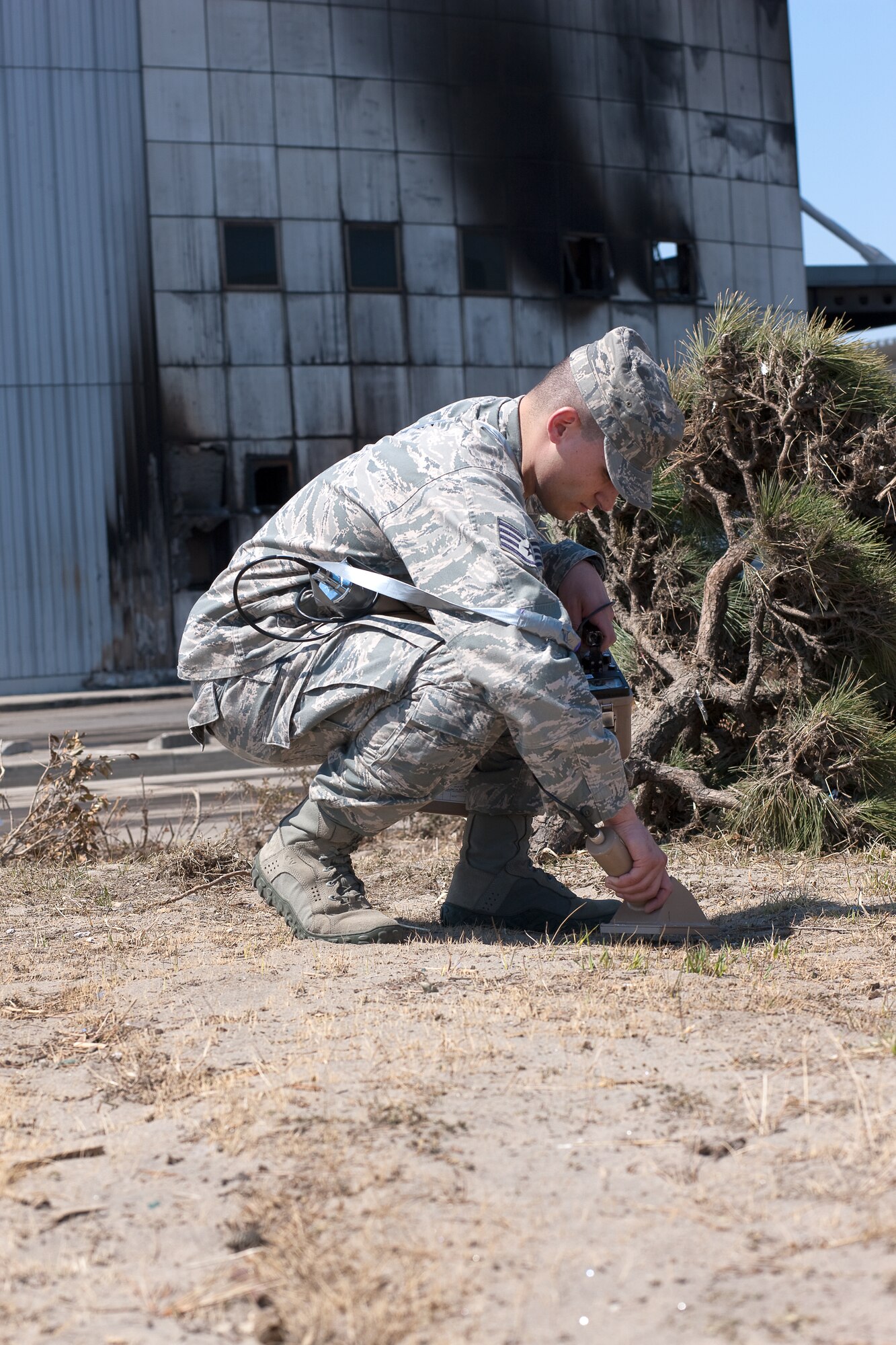 SENDAI AIRPORT, Japan -- Staff Sgt. Kevin Rivera, Air Force Radiation Assessment Team, checks soil at Sendai Airport for possible contamination April 5, 2011. The AFRAT provides commanders and other key decision-makers with risk-based recommendations to maximize force protection while meeting critical mission requirements. (U.S. Air Force photo/Osakabe Yasuo)  
