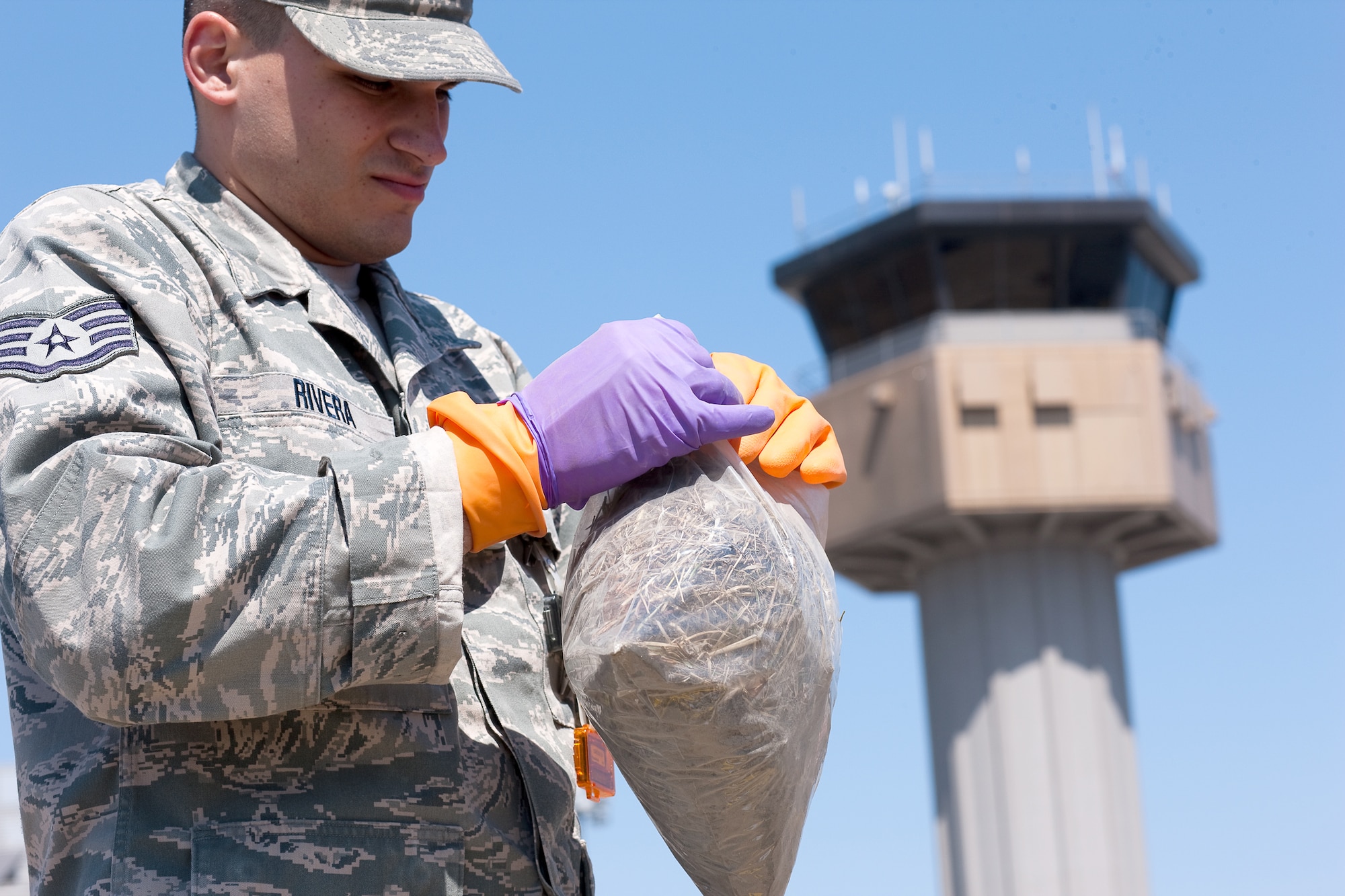 SENDAI AIRPORT, Japan -- Staff Sgt. Kevin Rivera, Air Force Radiation Assessment Team, collects a vegetation sample at Sendai Airport, April 05, 2011. The AFRAT provides commanders and other key decision-makers with risk-based recommendations to maximize force protection while meeting critical mission requirements. (U.S. Air Force photo/Osakabe Yasuo)  
 