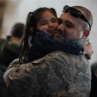 MINOT AIR FORCE BASE, N.D. – Staff Sgt. Ezekiel Brito, 5th Operations Support Squadron NCO in charge of aircrew flight equipment, embraces his daughter after returning home here on April 4 from a six month deployment to Andersen AFB, Guam. Minot’s 69th Bomb Squadron and 5th Bomb Wing personnel deployed to Andersen AFB last November in support of U.S. Pacific Command’s Continuous Bomber Presence. This was the 69th BS’ first deployment since it’s reactivation in September 2009 and the first major combat deployment of aircraft and personnel since World War II. (U.S. Air Force photo/Airman 1st Class Jose L. Hernandez)
