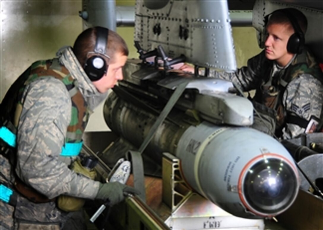 U.S. airmen with a weapons loading team from the 25th Fighter Squadron load bombs on an A-10 Thunderbolt II aircraft during the 2011 Korean Pacific Air Forces Command operational readiness inspection at Osan Air Base, South Korea, on April 4, 2011.  An operational readiness inspection is conducted to evaluate and measure the ability of units to perform operation plans and assigned tasks.  