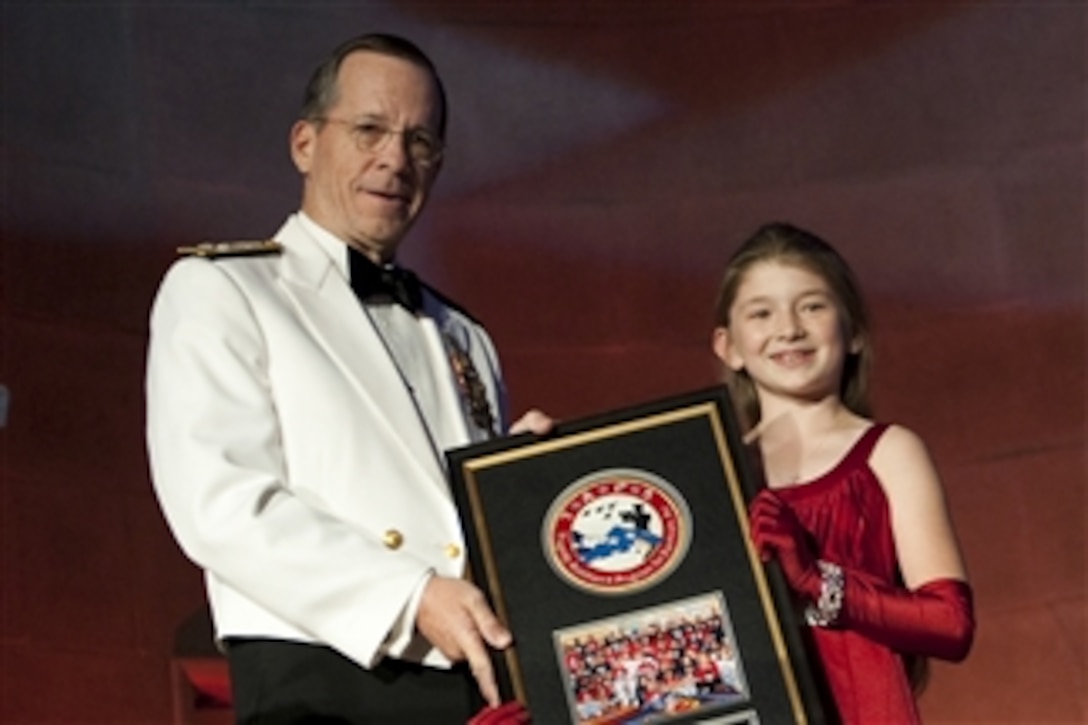 Cierra Becker presents Chairman of the Joint Chiefs of Staff Adm. Mike Mullen, U.S. Navy, with an appreciation award at the 2011Tragedy Assistance Program for Survivors Honor Guard Gala in Washington, D.C., on April 5, 2011.    