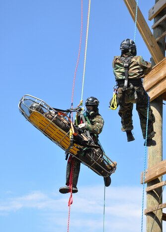 STUMP NECK ANNEX, Md. (April 6, 2011) Technical rescue platoon members with the Marine Corps Chemical Biological Incident Response Force, Sgt. Jafri Leahy (center) and Cpl. Michael Harvey (r.) demonstrate a high-to-high rope rescue at the command's Downey Responder Training Facility. While suspended three stories in the air, they secured an "unconscious" LCpl. Keith Saffran onto a rescue stretcher prior to lowering the victim to the ground. The demonstration was part of a day-long visit to CBIRF earlier this month by Lt.Gen. John Paxton Jr., Commanding General II Marine Expeditionary Force. (U.S. Navy photo by Gary Wagner/Released)
