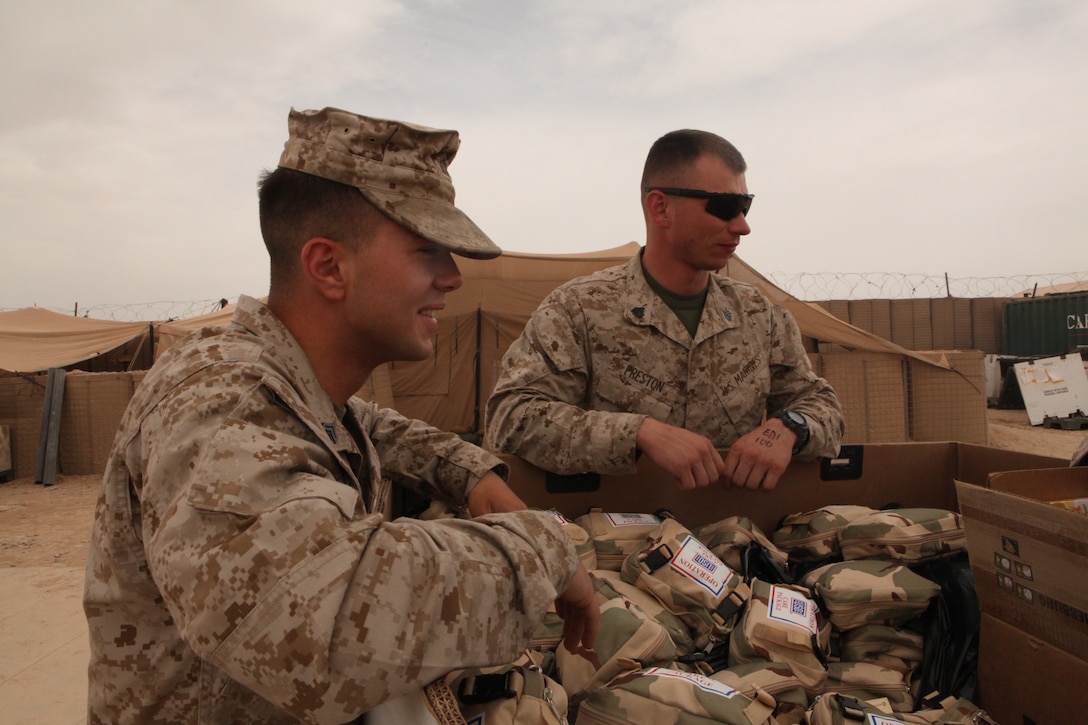 Sgt. Christopher L. Preston and Cpl. George N. English, who both provide security for the 2nd Marine Aircraft Wing (Forward) command group, gathered up and delivered additional supplies to fellow Marines at Forward Operating Base Edinburgh, Afghanistan, April 7. “It was rewarding for me to help fellow Marines,” said English. “We had the ability to share the supplies that we had with them.”