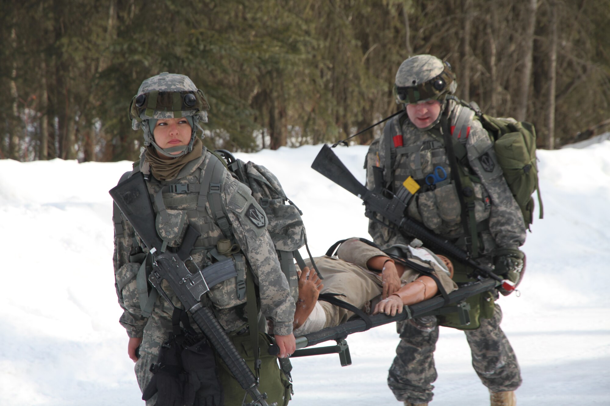JOINT BASE ELMENDORF-RICHARDSON, Alaska ? Spc. Lindsey M. Velez and Spc. David Burnos, 95th Chemical Company, carry a simulated casualty, March 21, near FOB Grizzly on Joint Base Elmendorf-Richardson. (U.S. Army photo by Staff Sgt. Jason Epperson/Released)