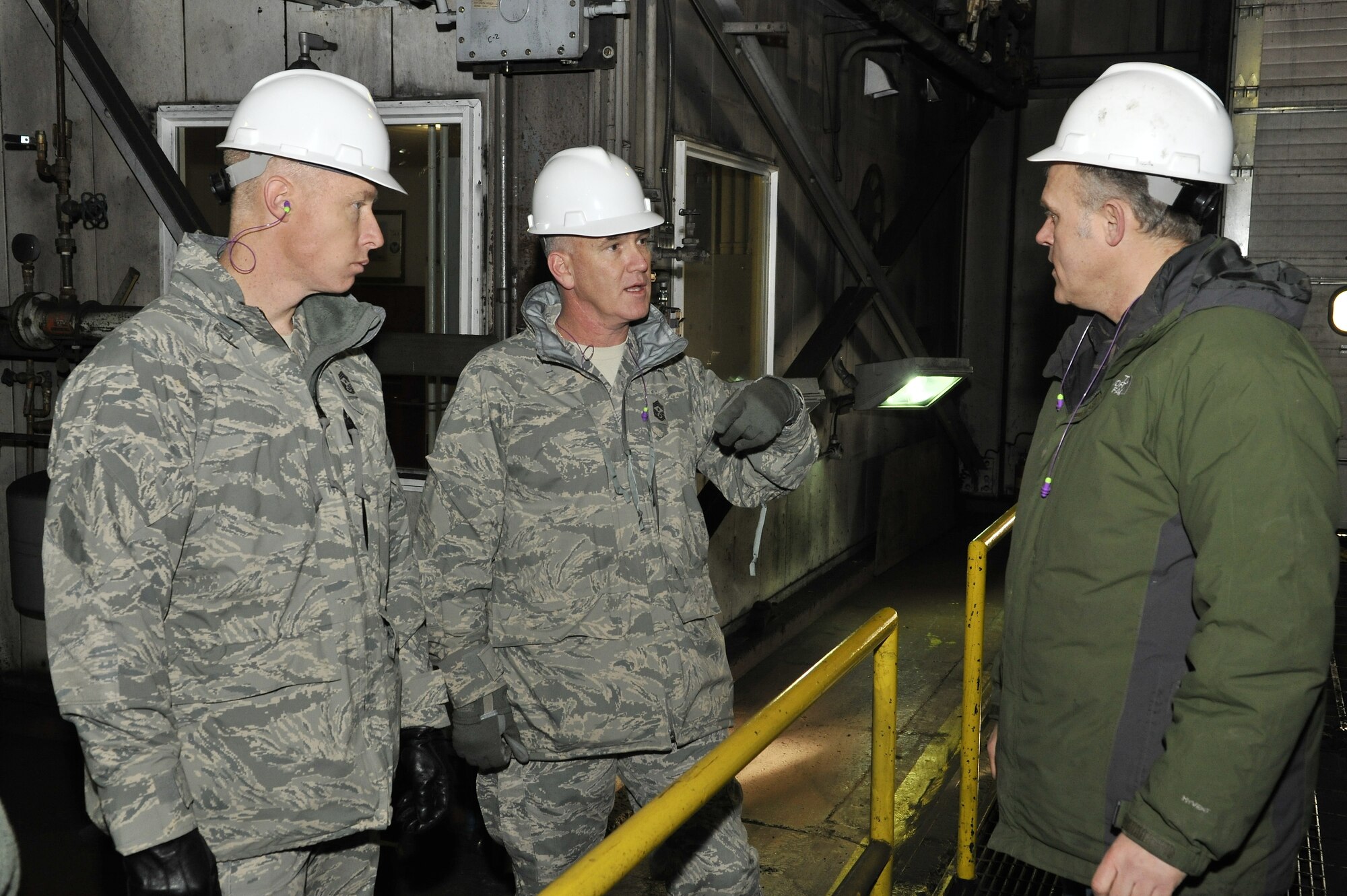 Chief Master Sgt. Brooke McLean and CMSgt. Michael Warner receive a tour from Marty Overlin of the base power plant Feb. 15, 2011, Eielson Air Force Base, Alaska. The power plant supplies Eielson's residents with electric and heat which is powered by coal. Chief McLean is the Pacific Air Forces Command Chief, Chief Warner is the Eleventh Air Force Command Chief and Mr. Overlin is the Superintendent of Central Heat, 354th Civil Engineer Squadron. (U.S. Air Force photo/Staff Sgt. Christopher Boitz)