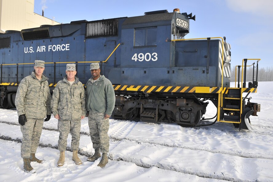 Left to right: Chief Master Sergeants Michael Warner, Brooke McLean and Jerry Moore stand next to a United States Air Force train Feb. 15, 2011, Eielson Air Force Base, Alaska. The train hauls coal to Eielson power plant which provides electricity and heat for Airmen and their families. Chief Warner is the Eleventh Air Force Command Chief, Chief McLean is the Pacific Air Forces Command Chief and Chief Moore is the 354th Fighter Wing Command Chief. (U.S. Air Force photo/Staff Sgt. Christopher Boitz)