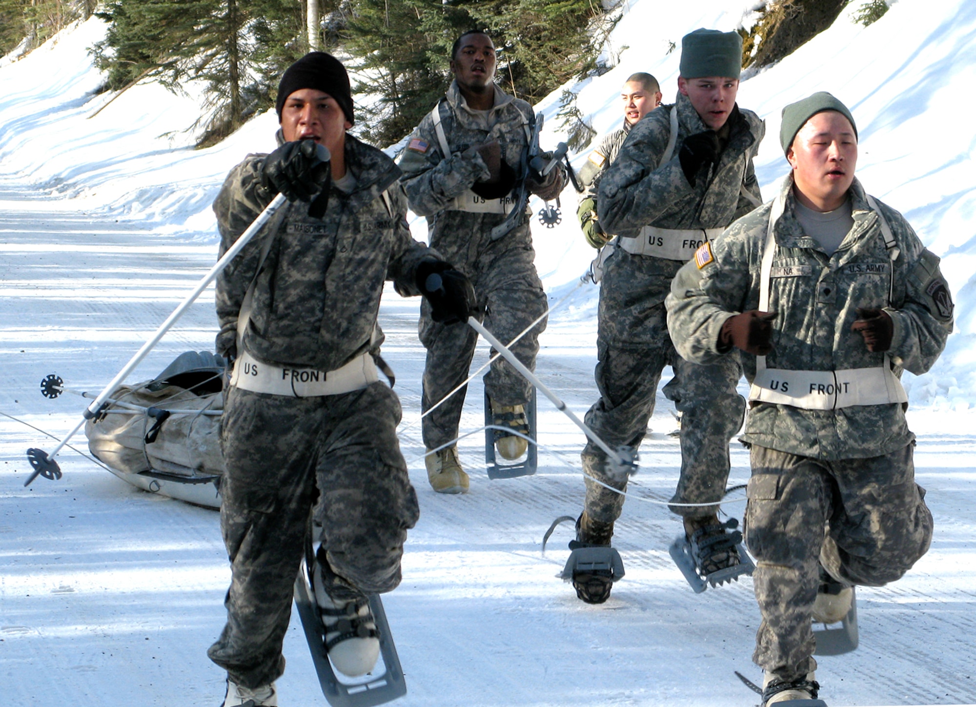 JOINT BASE ELMENDORF-RICHARDSON, Alaska ? The 84th Engineer Support Company?s ahkio-sled-pull team nears the finish line, March 15, in the 6th Engineer Battalion?s Arctic Sapper Winter Olympic Games. Soldiers of 84th ESC won the event when they defeated Headquarters and Headquarters Company in the final event, Small Unit Support Vehicle skijoring. (Courtesy photo)