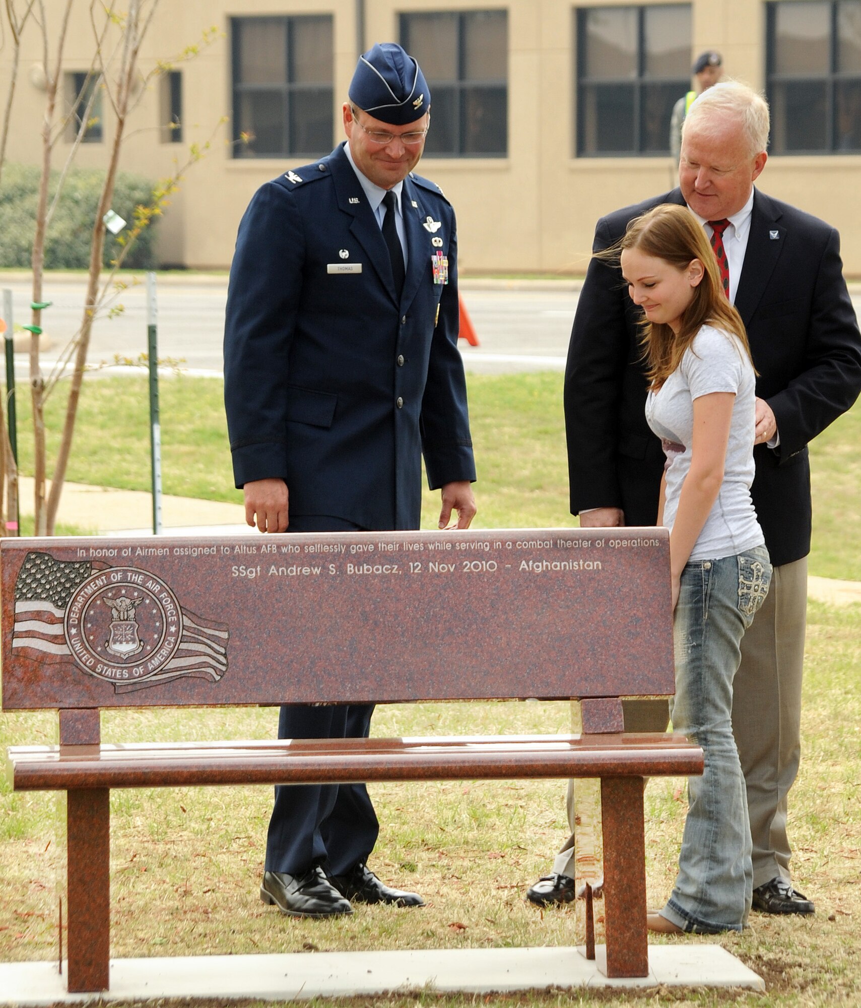 ALTUS AIR FORCE BASE, Okla. -- Col. Jon T. Thomas, 97th Air Mobility Wing commander; Dr. Joe Leverett, Altus Military Affairs Committee chairman; and Ashley Bubacz, widow to Staff Sgt. Andrew S. Bubacz, admire the memorial bench during the unveiling ceremony in the Wings of Freedom Park here April 7. Sergeant Bubacz died Nov. 12 while deployed to Afghanistan and was the first Altus Airman to die while supporting Operation Enduring Freedom. A forested area within the Wings of Freedom Park was designated as the Combat Airmen's Grove to recognize Altus Airmen who have fallen in a combat theater of operation along with a granite bench donated by the Altus Military Affairs Committee, upon which the names of the fallen Airmen are inscribed. (U.S. Air Force photo by Airman 1st Class Kenneth W. Norman/ Released 97th Air Mobility Wing Public Affairs)