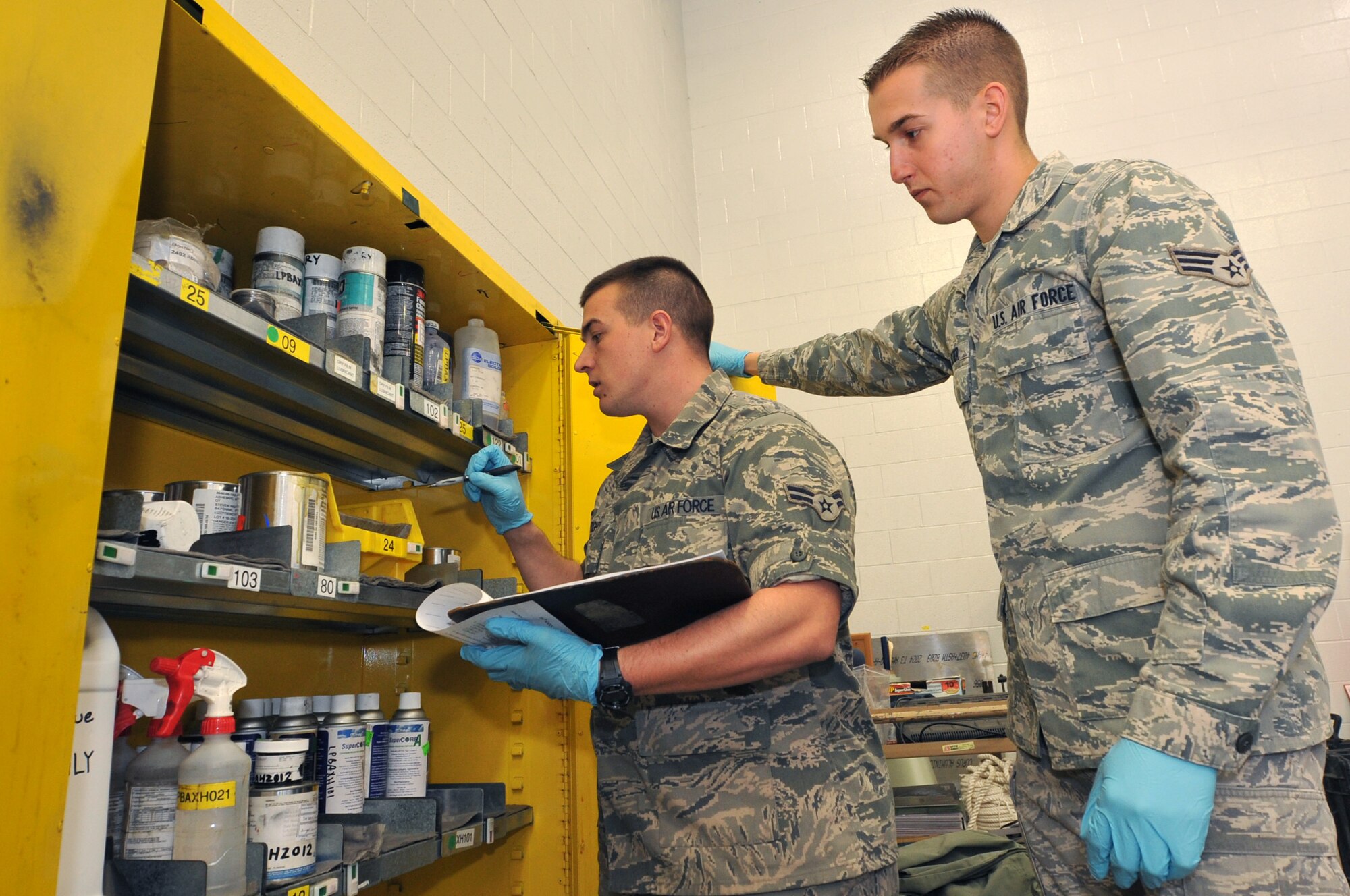 Senior Airman Justin Sliter (right), a 314th Aircraft Maintenance Squadron consolidated tool kit custodian, trains Airman 1st Class William Wright, a 314th AMXS consolidated tool kit custodian, how to inventory the hazardous material lockers March 24, 2011, at Little Rock Air Force Base, Ark. Airman Sliter performs inventory at the beginning of every shift for total accountability of equipment. (U.S. Air Force photo by Airman 1st Class Rusty Frank)