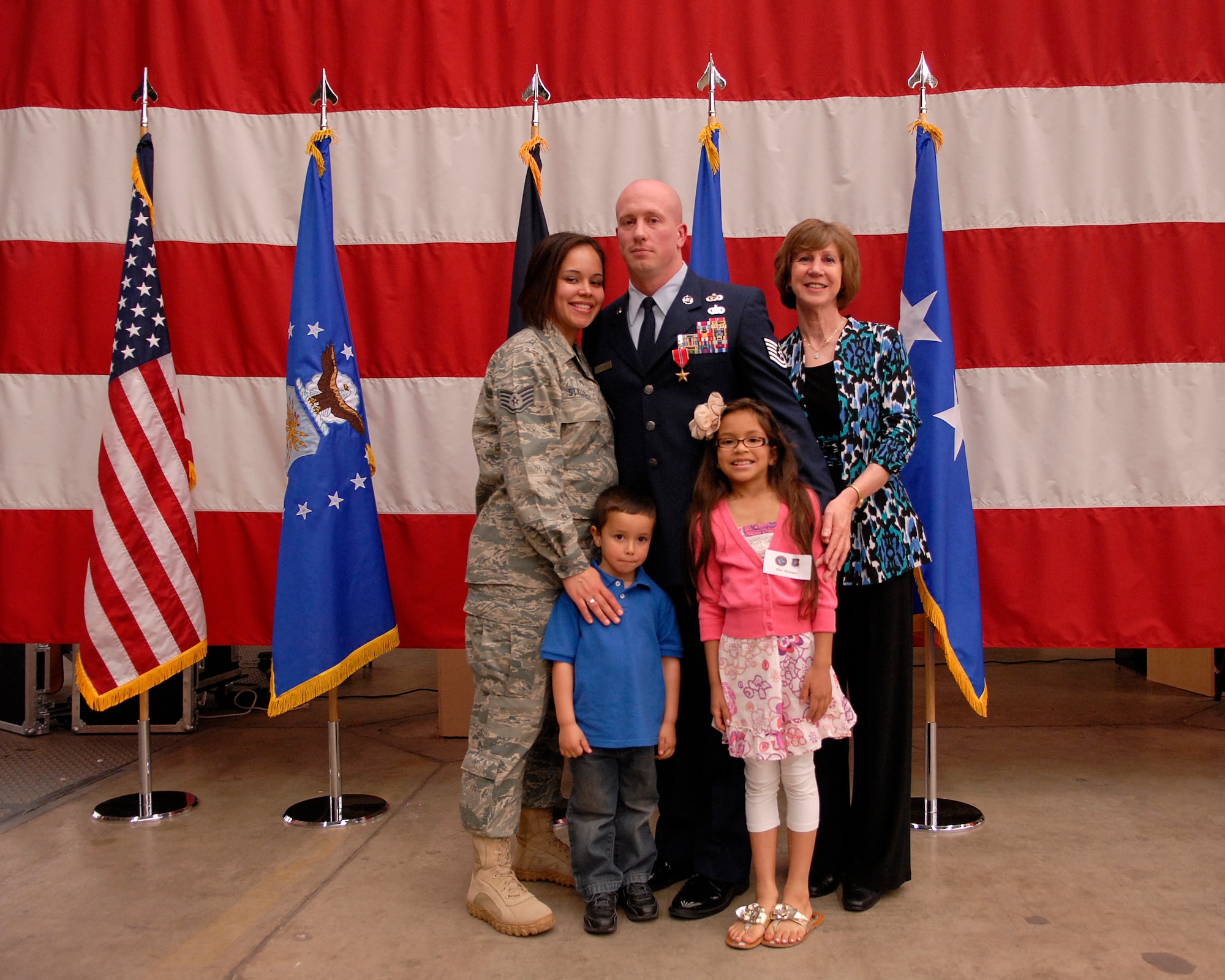 VANDENBERG AIR FORCE BASE, Calif. - Tech. Sgt. Richard Styles, from the 614th Air and Space  Operations Center, enjoys a moment with his mother, Amy, wife, Staff Sgt. Jessica Styles, daughter, Monique, and son, Aiden, following a ceremony in which Lt. Gen. Susan Helms, Joint Functional Component Command for Space and 14th Air Force Commander, presented him with a Bronze Star Medal on Tuesday, April 5, 2011. Sergeant Styles was deployed from May to October 2010 as an intelligence analyst in both Iraq and Afghanistan. While in Iraq, he served with a Joint Special Operations Task Force and led 68 outside-the-wire collection missions. He is also credited with working with international security and coalition partners to identify more than a dozen high valued targets and to provide information about a number of key Al-Qaeda networks. While in Afghanistan, Sergeant Styles was a
liaison officer to the International Security Assistance Force and worked
with the government of Afghanistan to help capture several senior Al-Qaeda leaders. (U.S. Air Force photo/Staff Sgt. Andrew M. Satran)