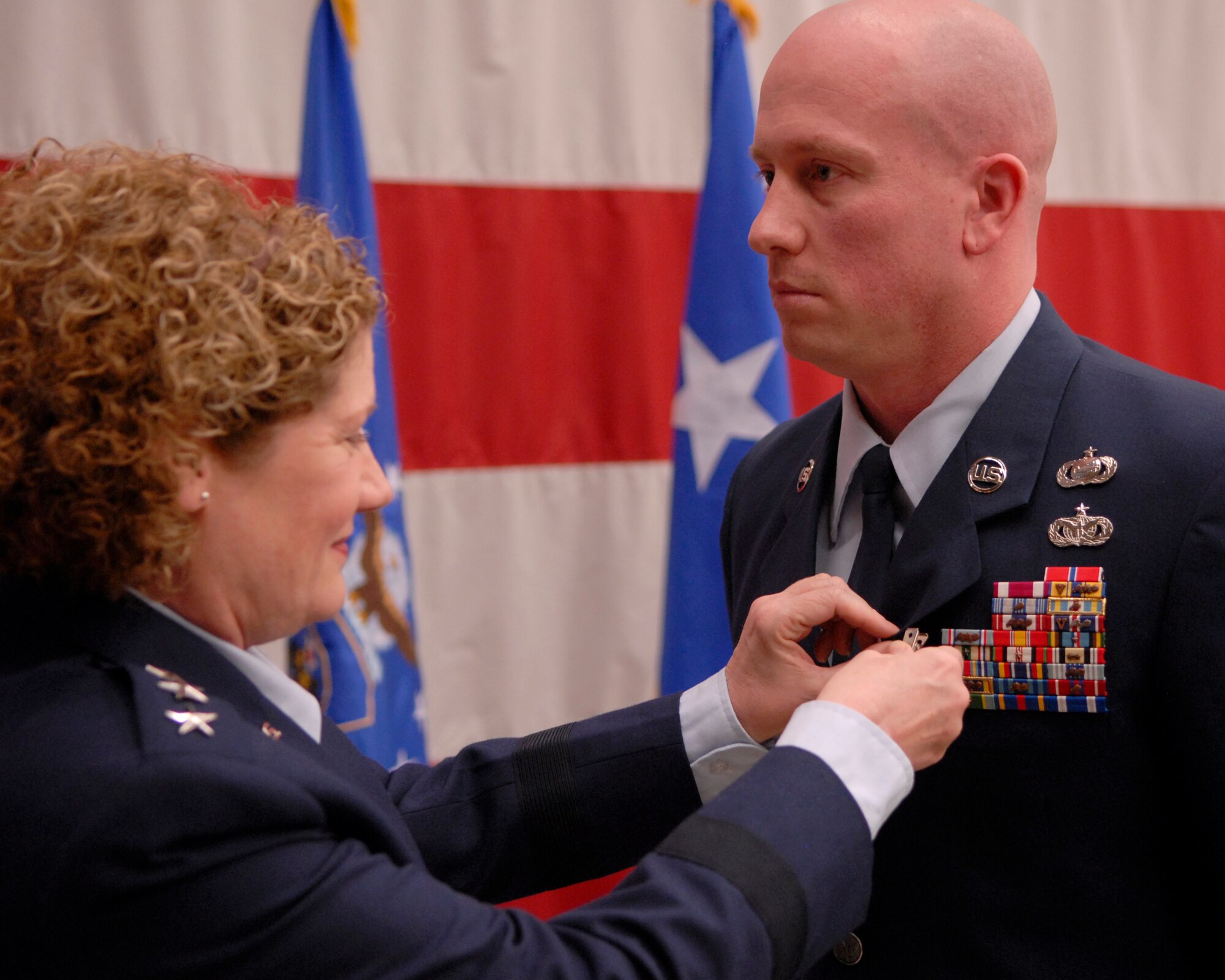 VANDENBERG AIR FORCE BASE, Calif. -- VANDENBERG AIR FORCE BASE, Calif. - Lt. Gen. Susan Helms, Joint FunctionalComponent Command for Space and 14th Air Force commander, awards the Bronze Star Medal to Tech. Sgt. Richard Styles, from the 614th Air and Space Operations Center, during a ceremony here Tuesday, April 5, 2011. Sergeant Styles was deployed from May to October 2010 as an intelligence analyst in both Iraq and Afghanistan. While in Iraq, he served with a Joint Special Operations Task Force and led 68 outside-the-wire collection missions. He is also credited with working with international security and coalition partners to identify more than a dozen high valued targets and to provideinformation about a number of key Al-Qaeda networks. While in Afghanistan, Sergeant Styles was a liaison officer to the International Security Assistance Force and worked with the government of Afghanistan to help capture several senior Al-Qaeda leaders. (U.S. Air Force photo/Staff Sgt. Andrew M. Satran) 

 