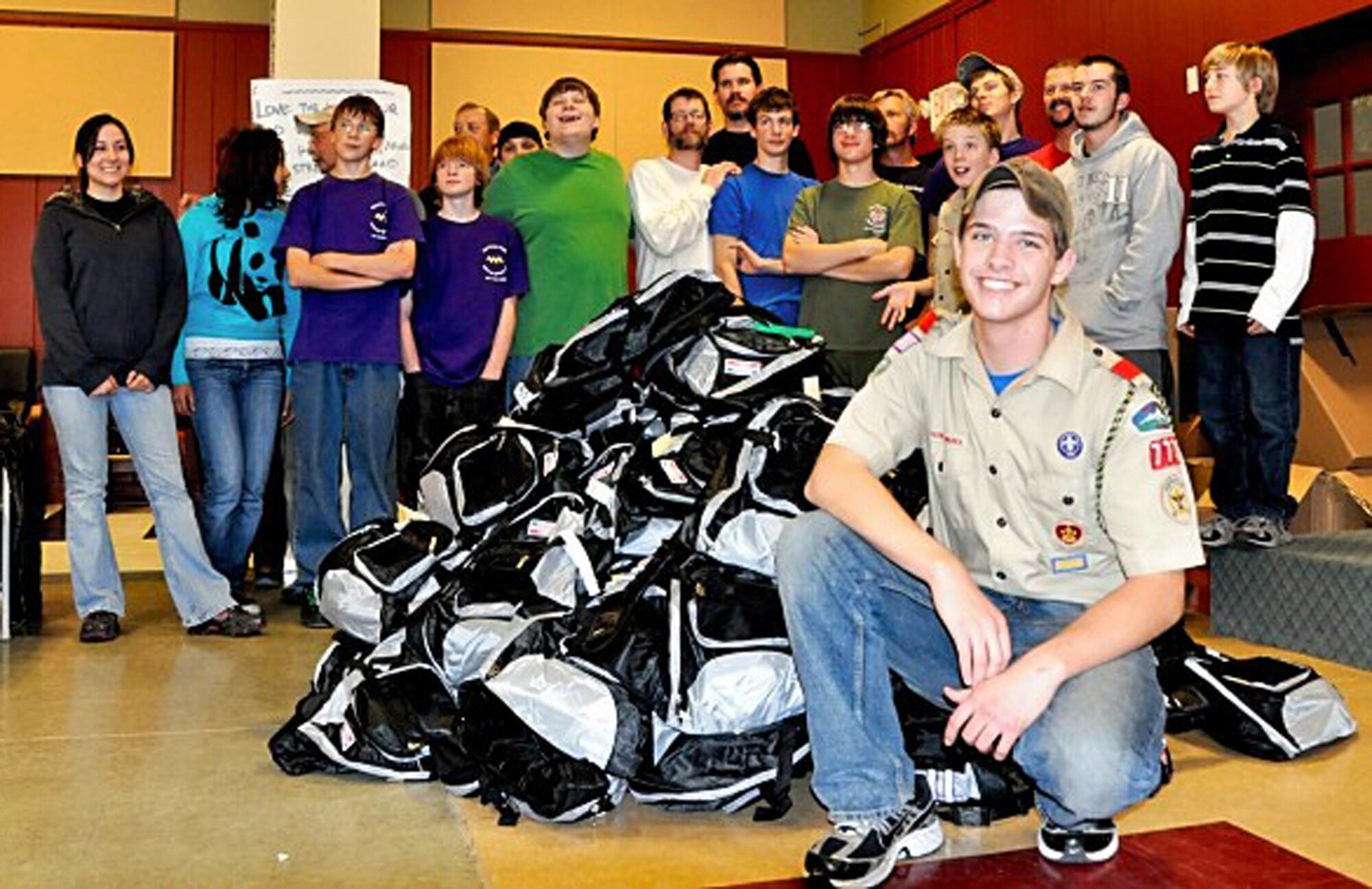Eagle Scout Seamus Severance poses in front of some of the 150 backpacks he helped make for children of deployed Airmen. Mr. Severance, a sophomore at Vista Ridge High School, and his team of volunteers made the "Hero Packs" as part of an Eagle Scout service project. (Courtesy photo)