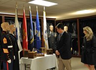 Members of the USO Board of Governors view a sample flag case in the uniform preparation section at the Charles C. Carson Center for Mortuary Affairs during a tour April 6, 2011. The BOG toured the Center for Families of the Fallen and the Meditation Pavilion at the Fisher House for Families of the Fallen. (U.S. Air Force photo/Christin Michaud)
