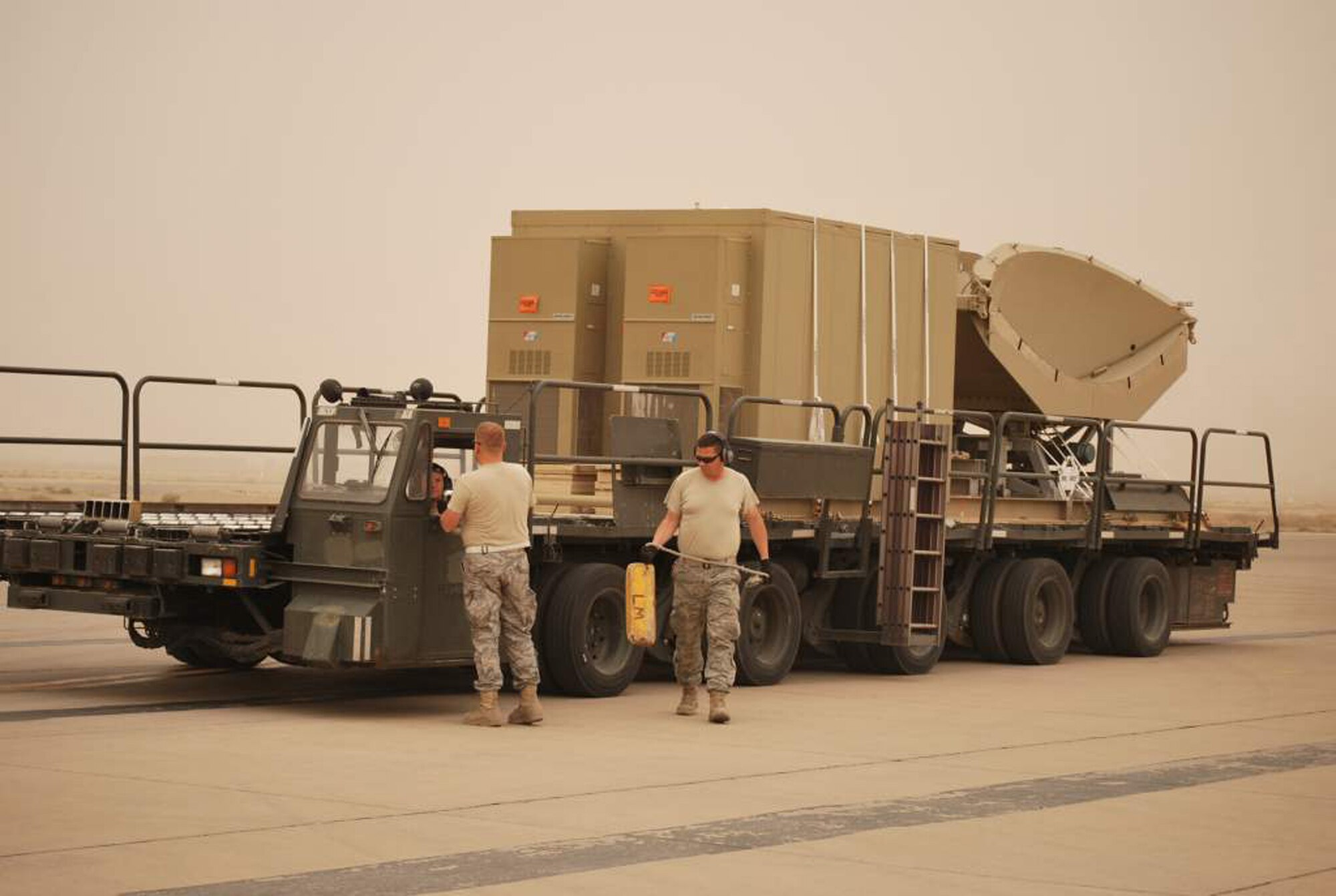 WRIGHT-PATTERSON AIR FORCE BASE, Ohio – Tech. Sgt. Bob Castle, 445th Airlift Wing’s 87th Aerial Port Squadron, ramp team chief, air transportation craftsman, removes chalks from a 60K loader as the driver, Staff Sgt. James Mellenkamp, 87 APS, air transportation journeyman, coordinates the move of his equipment load with Tech. Sgt. Myles Kvilvang, 67th Aerial Port Squadron, Hill Air Force Base, Utah, April 4. The Airmen are currently deployed with the 332nd Expeditionary Logistics Readiness Squadron, Joint Base Balad, Iraq. (U.S. Air Force photo/Senior Master Sgt. Jack B. Lake, III)