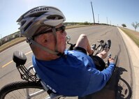 Tech. Sgt. Israel Del Toro, 342nd Training Squadron, steers his custom made recumbent bike past Forbes Hall during a training ride at the Lackland Training Annex April 5. The recumbent bike 10K is one of five events Sergeant Del Toro is preparing for in anticipation of his participation in the 2011 Wounded Warrior Games May 16-21. (U.S. Air Force photo/Robbin Cresswell)