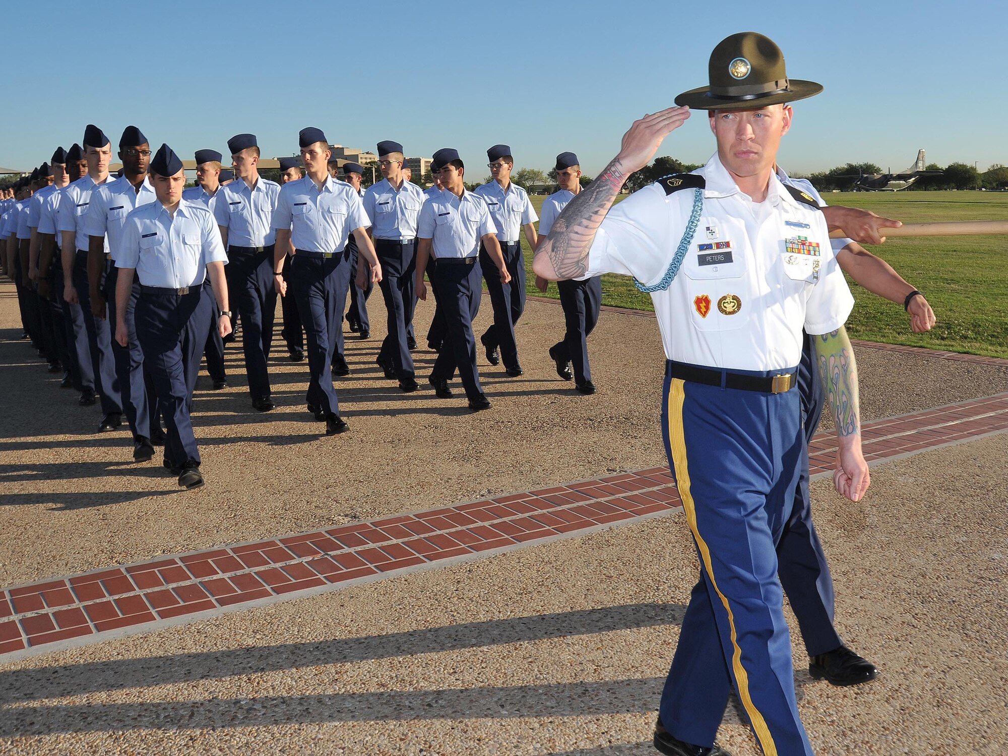 Army Staff Sgt. David Peters leads Flight 258 from the 322nd Training Squadron down the bomb run on the Air Force Basic Military Training parade grounds during graduation practice April 5. (U.S. Air Force photo/Alan Boedeker)