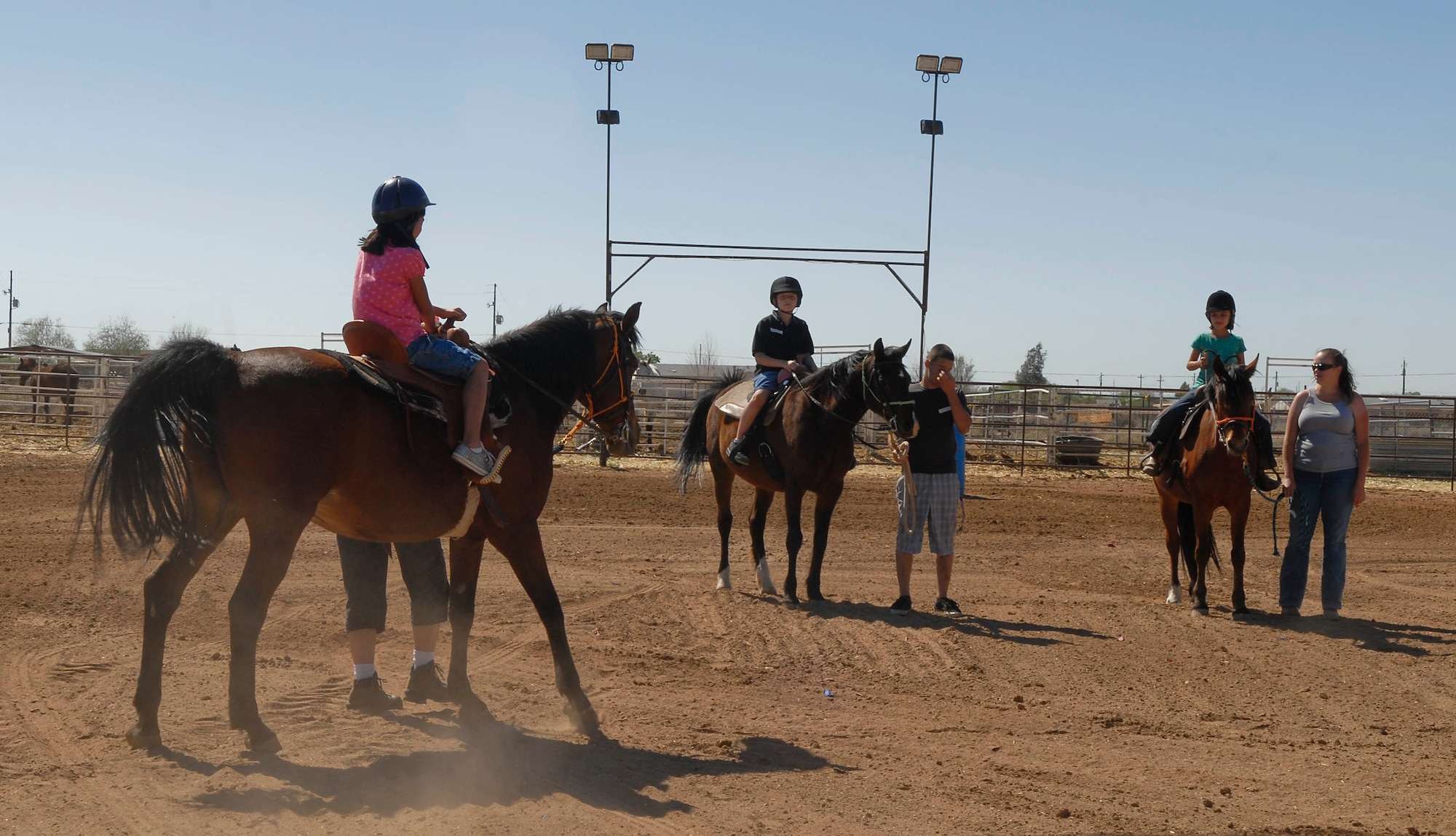 One team of children wait for instructions April 3 during their riding session at the Hearts Apart event at Sunset Ranch in Buckeye, Ariz. Trained instructors teach the children the basics on horseback riding, grooming and tacking.
(U.S. Air Force photo/Senior Airman Darlene Seltmann)
