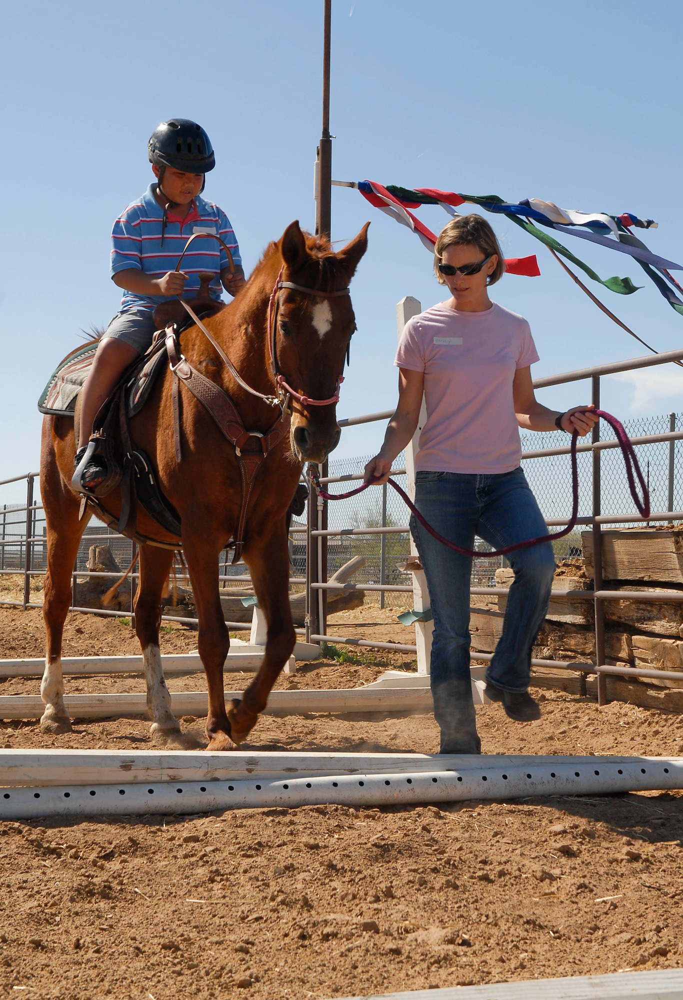 Zion, 9, is steered though a riding course April 3 during the Hearts Apart event at Sunset Ranch in Buckeye, Ariz. To accommodate more children the event took place at two locations. Sunset ranch hosted 10 children and Horses Help, in Northern Phoenix, hosted 27 children. (U.S. Air Force photo/Senior Airman Darlene Seltmann)