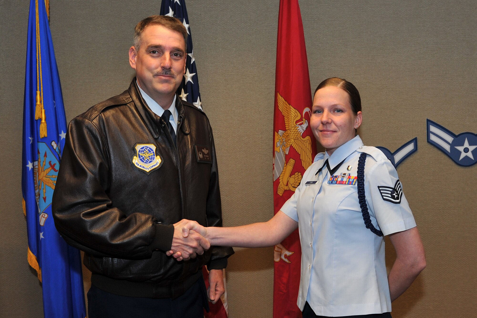 Col. Mike Minihan (left), 19th Airlift Wing commander, presents his commander’s coin March 28, 2011, to Staff Sgt. Laura Winn, a 373rd Training Squadron military training leader, at Little Rock Air Force Base, Ark. Sergeant Winn is responsible for maintaining and enforcing all standards and discipline for 750 Airman in training annually. (U.S. Air Force photo/Staff Sgt. Chris Willis)