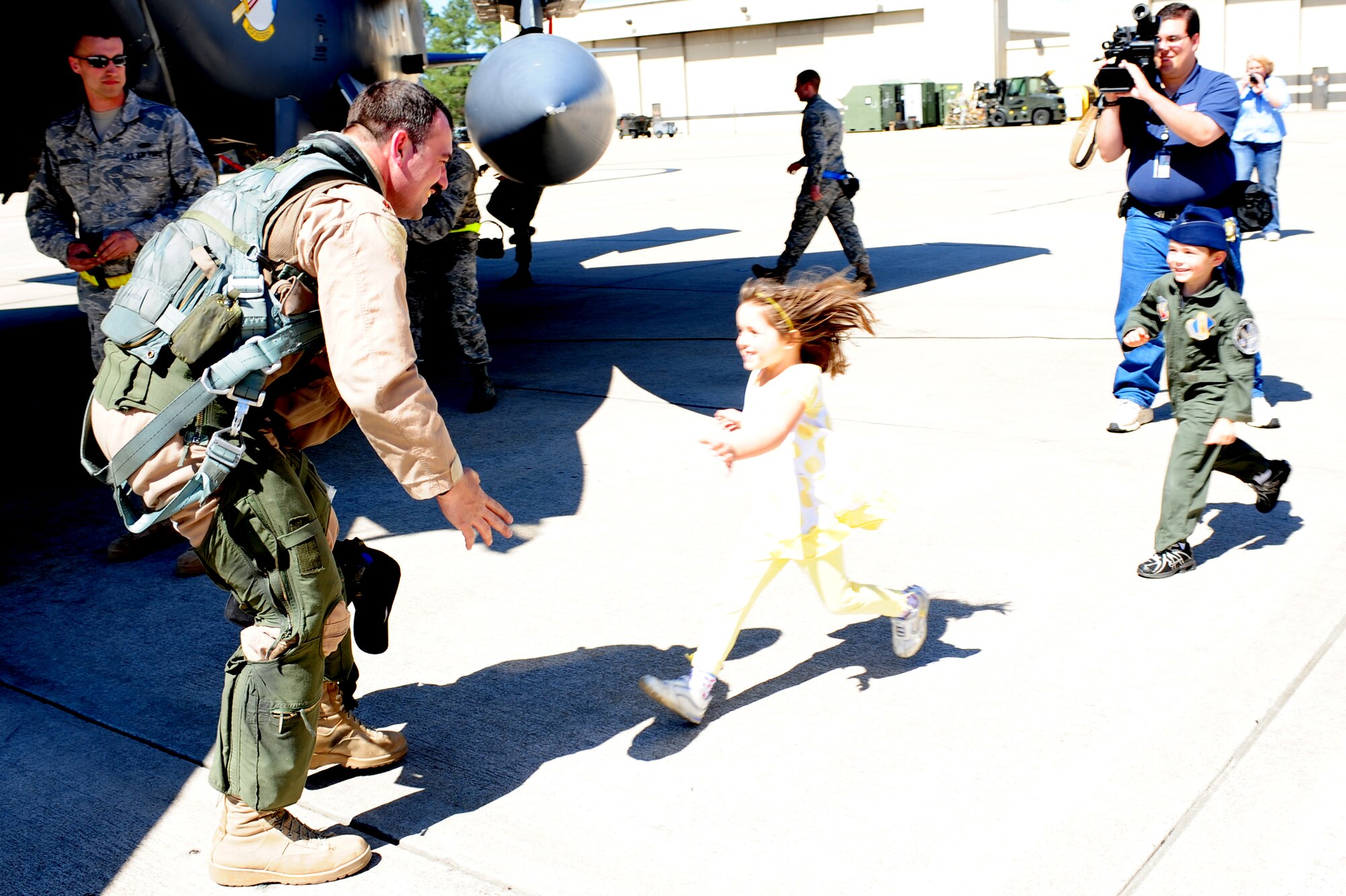 SEYMOUR JOHNSON AIR FORCE BASE, N.C. -- Alyssa and Steven Bruggeman rush to see their father, Maj. Kurt Bruggeman, here April 6, 2011. Major Bruggeman returned from a seven-month deployment to Afghanistan with the final four-ship of 336th Fighter Squadron F-15E Strike Eagles who stayed behind to complete turn over with the incoming squadron. Bruggeman hails from Quantico, Va. (U.S. Air Force photo/Senior Airman Rae Perry) (RELEASED)