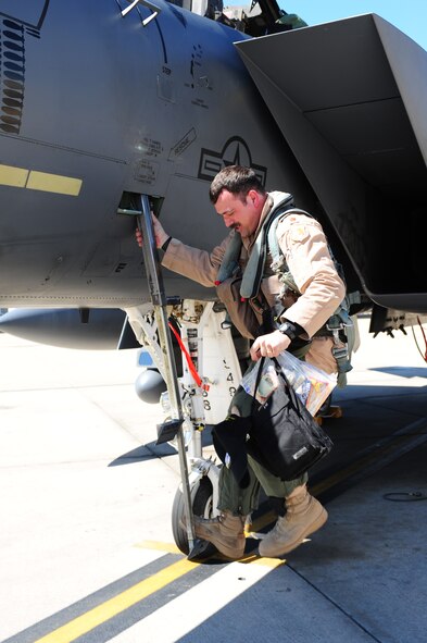 SEYMOUR JOHNSON AIR FORCE BASE, N.C. -- Maj. Kurt Bruggeman takes his first step on American soil after returning from a seven-month deployment to Afghanistan, April 6, 2011. The last four-ship from the 336th Fighter Squadron arrived three weeks after the first group of jets returned to help give the incoming squadron a chance to get settled in. Major Bruggeman hails from Quantico, Va. (U.S. Air Force photo/Senior Airman Rae Perry) (RELEASED)