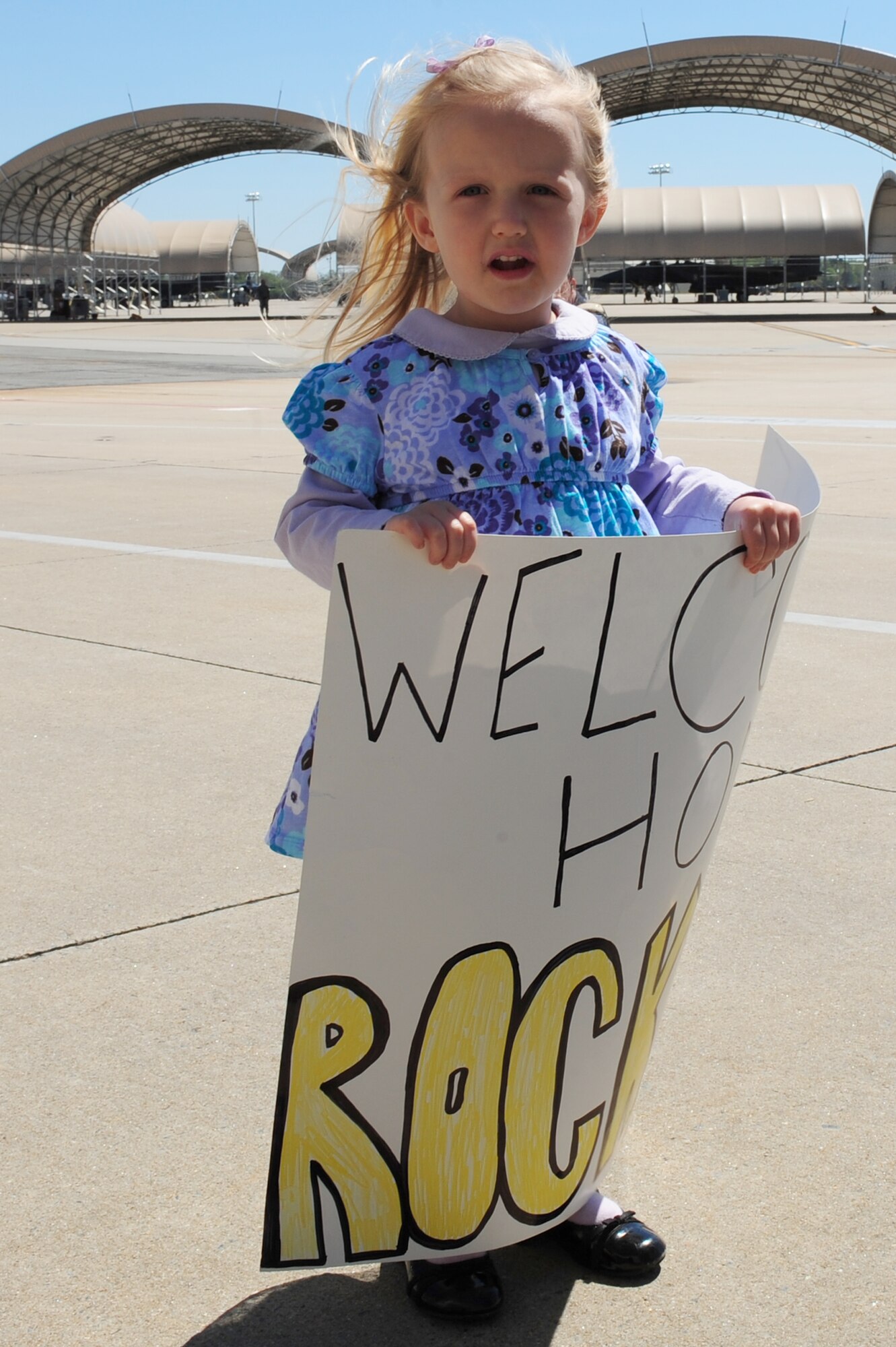 SEYMOUR JOHNSON AIR FORCE BASE, N.C. -- Lindsey Howard waits near her father, Lt. Col. Jim Howard, to welcome home the remaining 336th Fighter Squadron Rockets here April 6, 2011. The eight aircrew members were the last group to return after a seven-month deployment to Bagram Airfield, Afghanistan. Colonel Howard hails from Centerville, Utah. (U.S. Air Force photo/Senior Airman Rae Perry) (RELEASED)